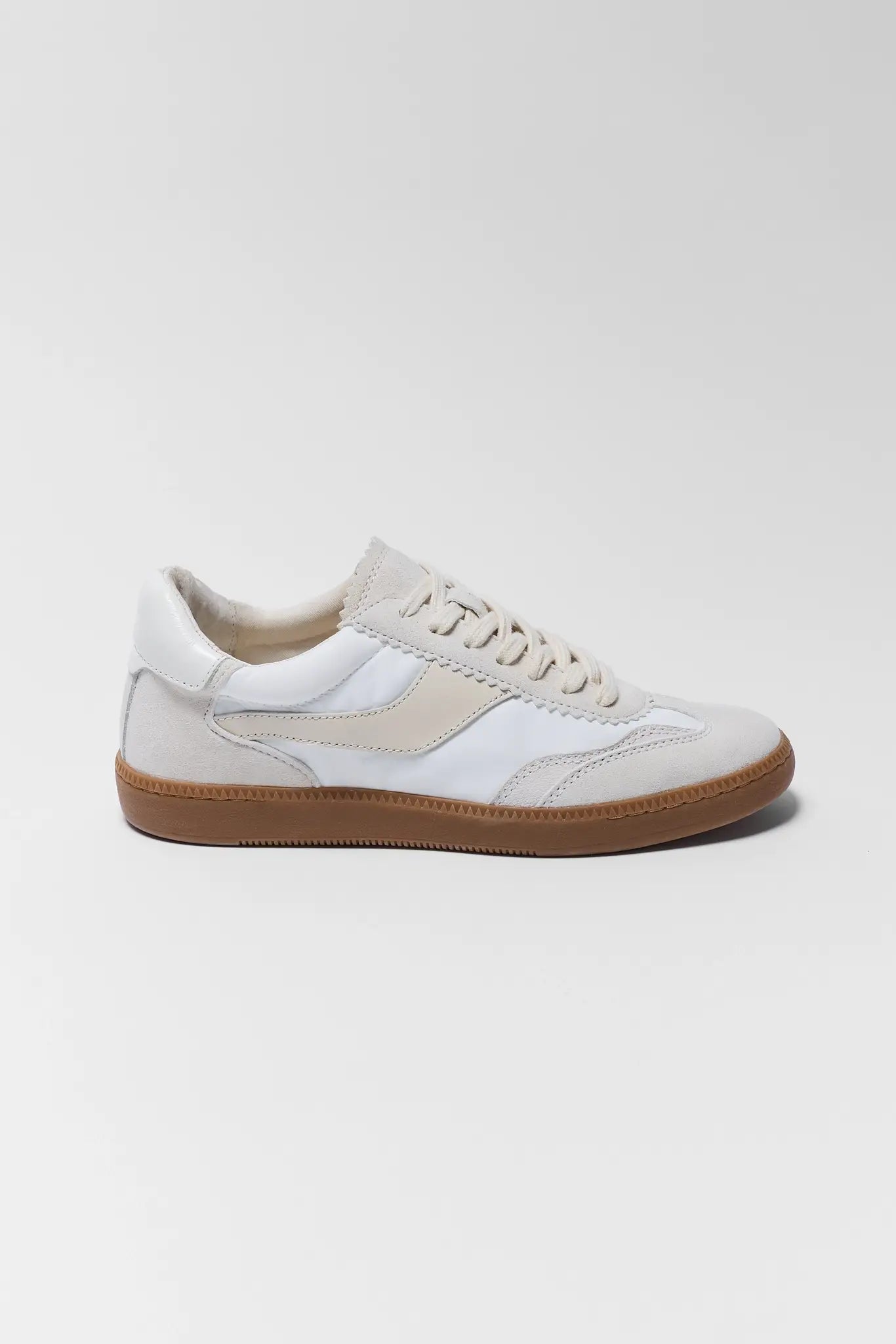 White sneaker with brown sole on a white background