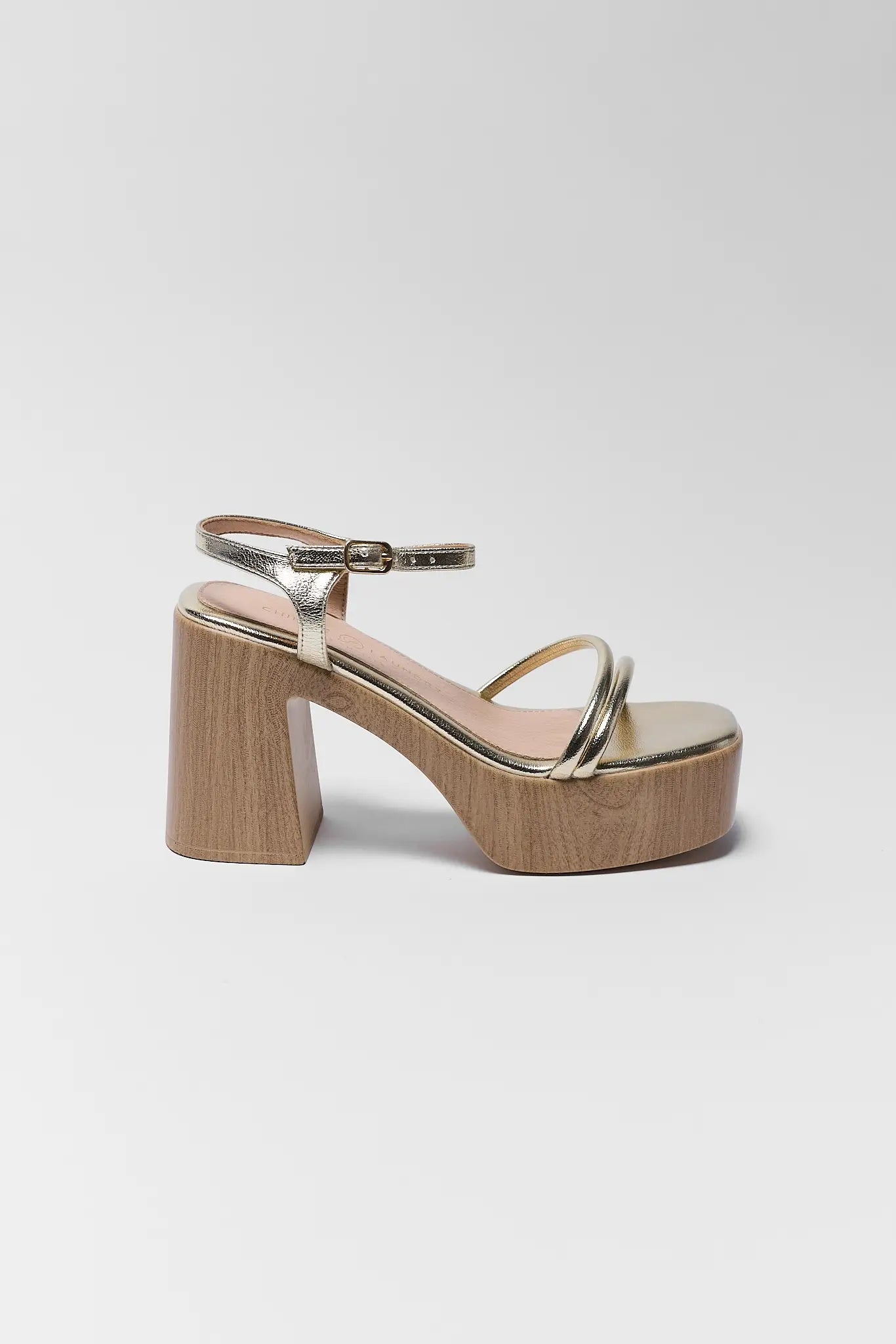 Gold platform sandal on a white background