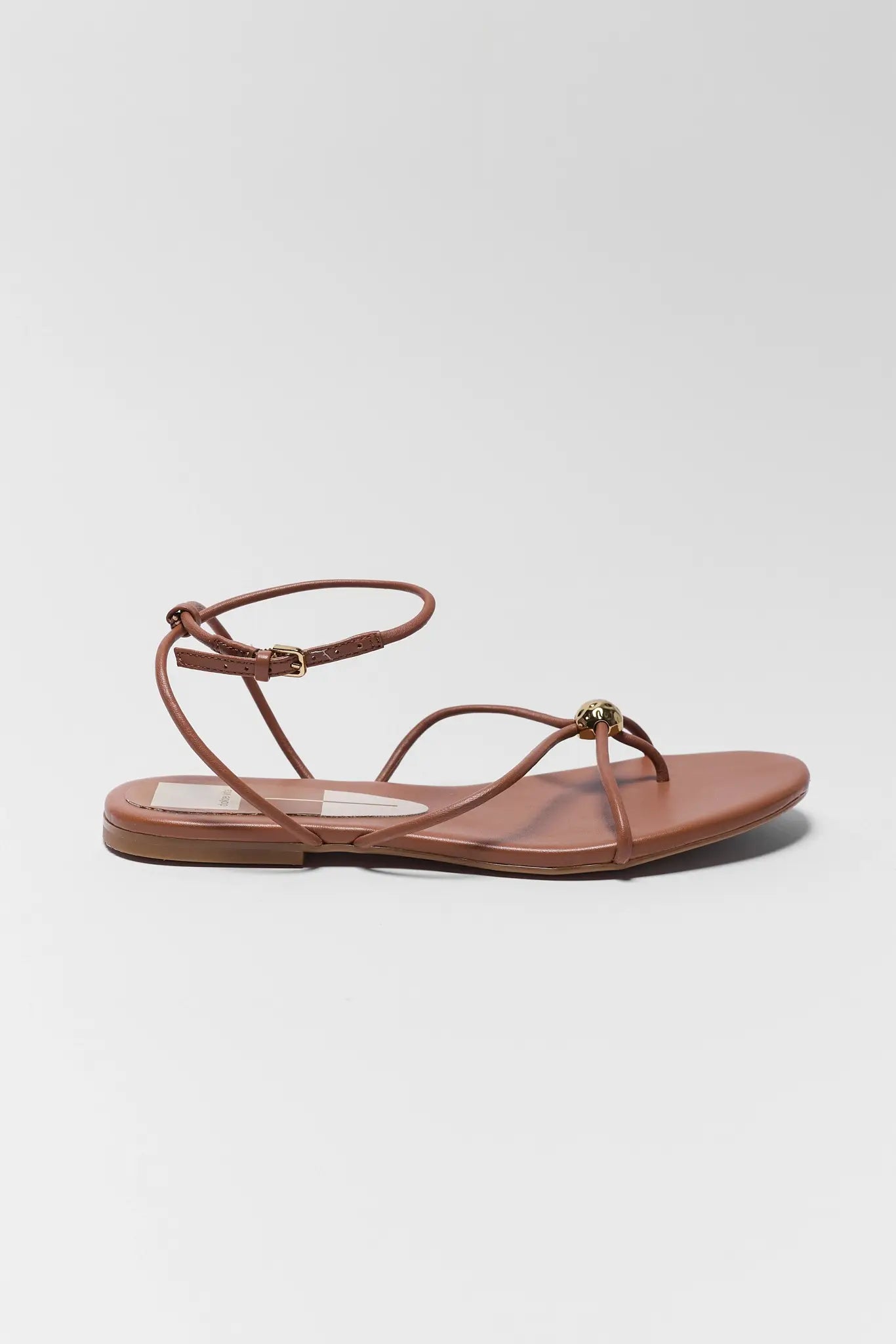 Brown sandal with thin straps on a white background