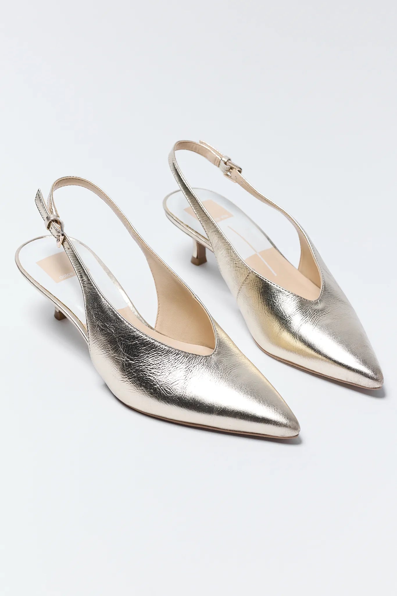 Pair of Alenna Gold Pointed Toe Heels on a light gray background