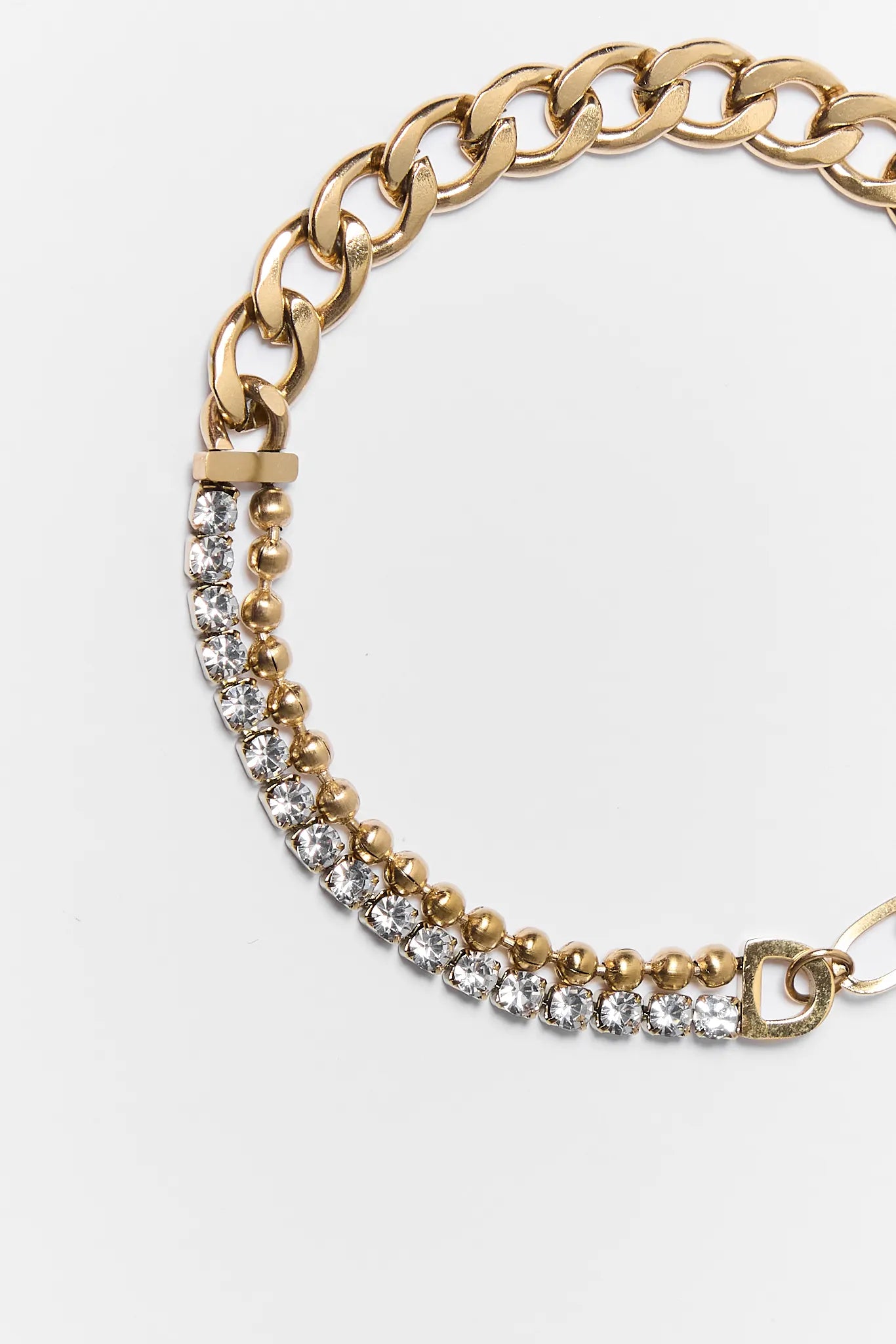 Gold chain bracelet with embedded crystals on a white background