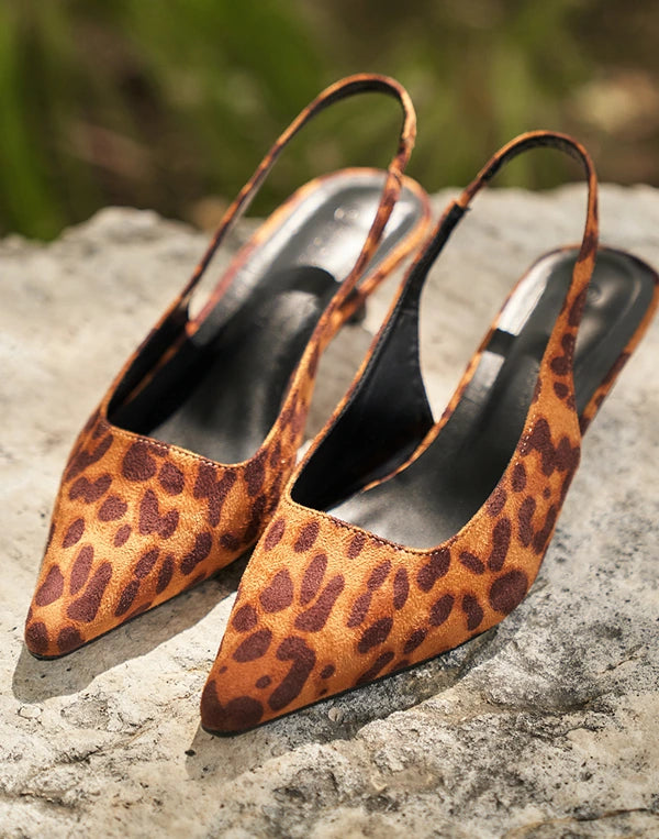Leopard print high Celia heels on a stone surface with a blurred natural background