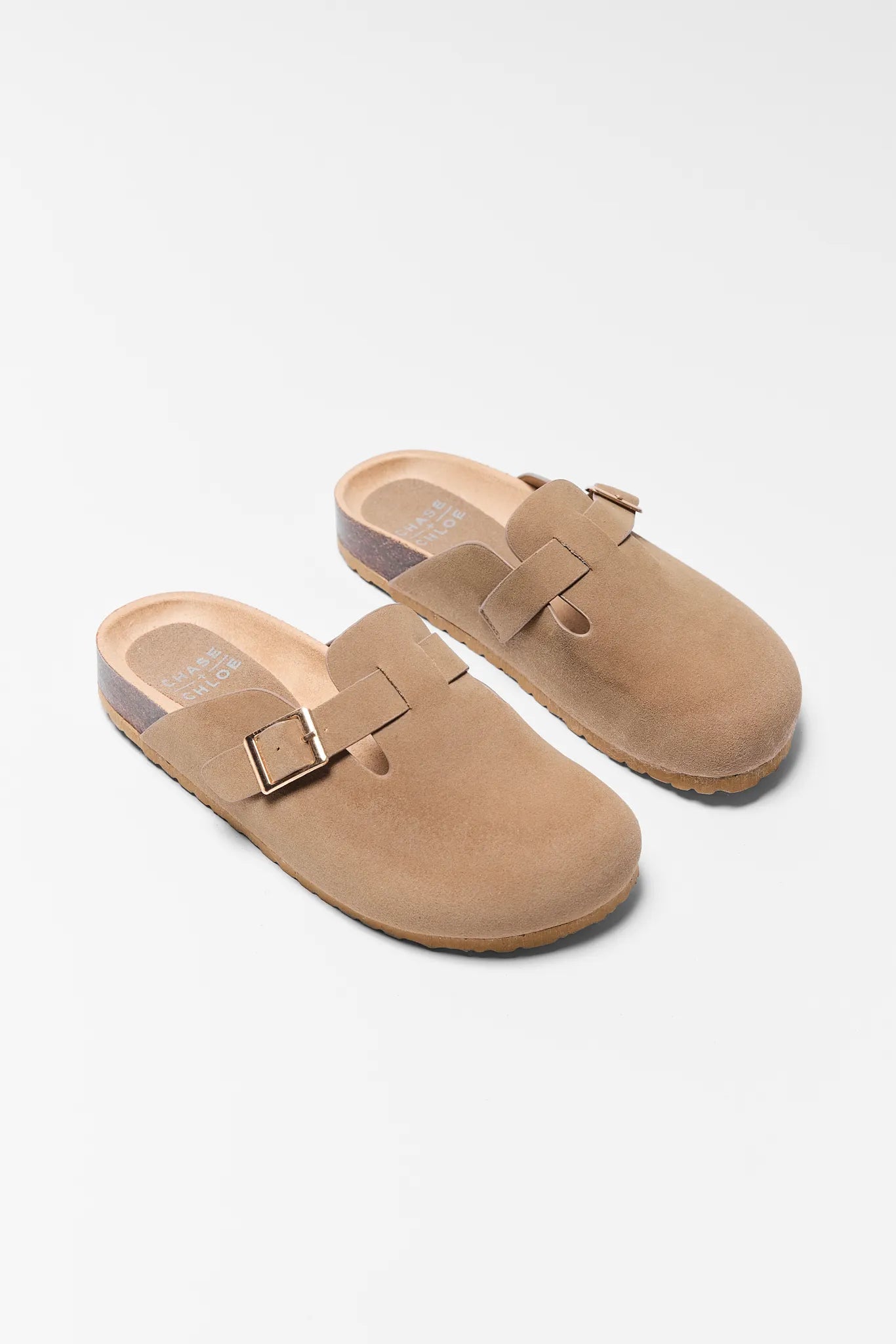 Pair of tan suede clogs with buckles on a white background Amelia Tan Faux Suede Mules