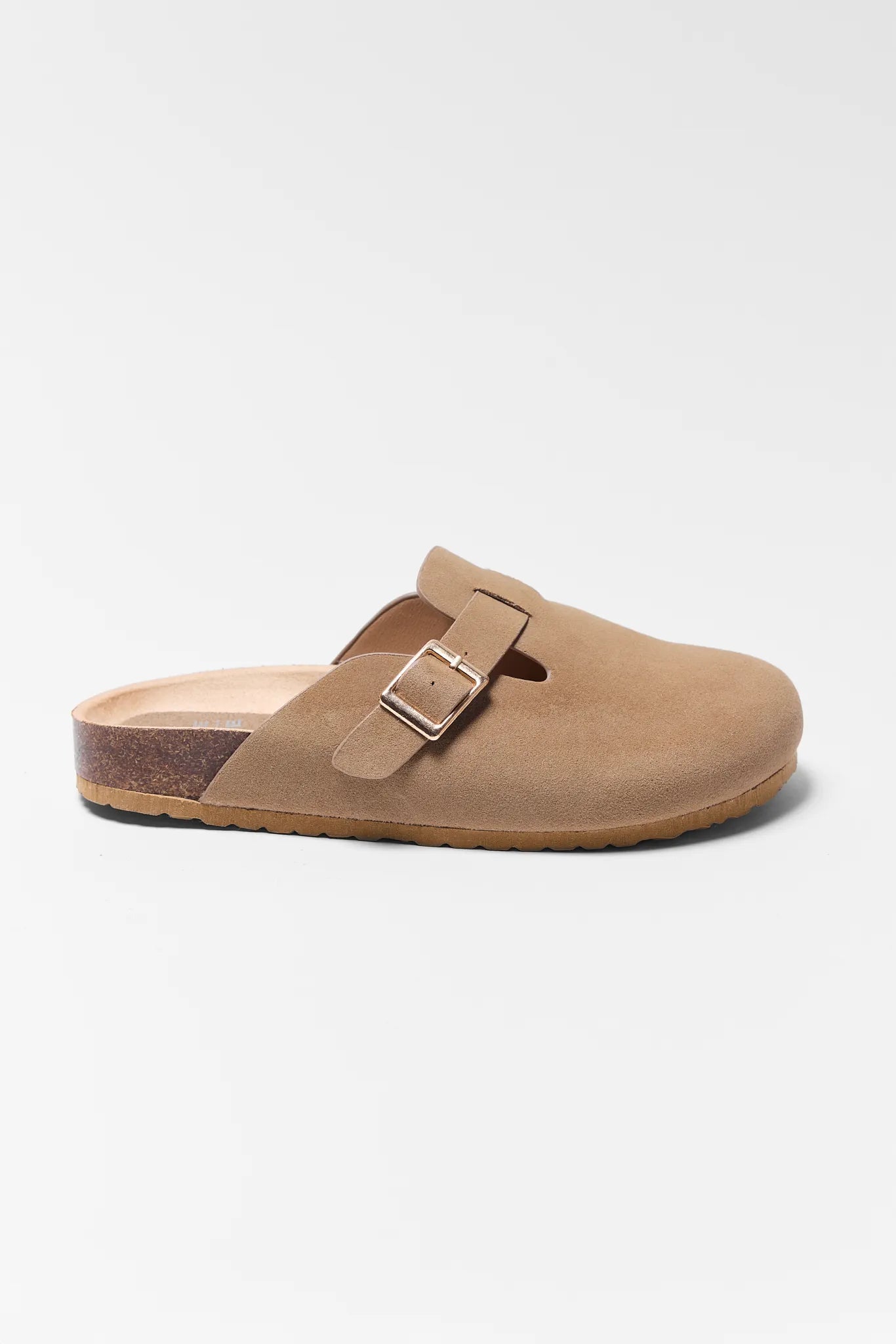 Tan sandal with a buckle on a white background Amelia Tan Faux Suede Mules