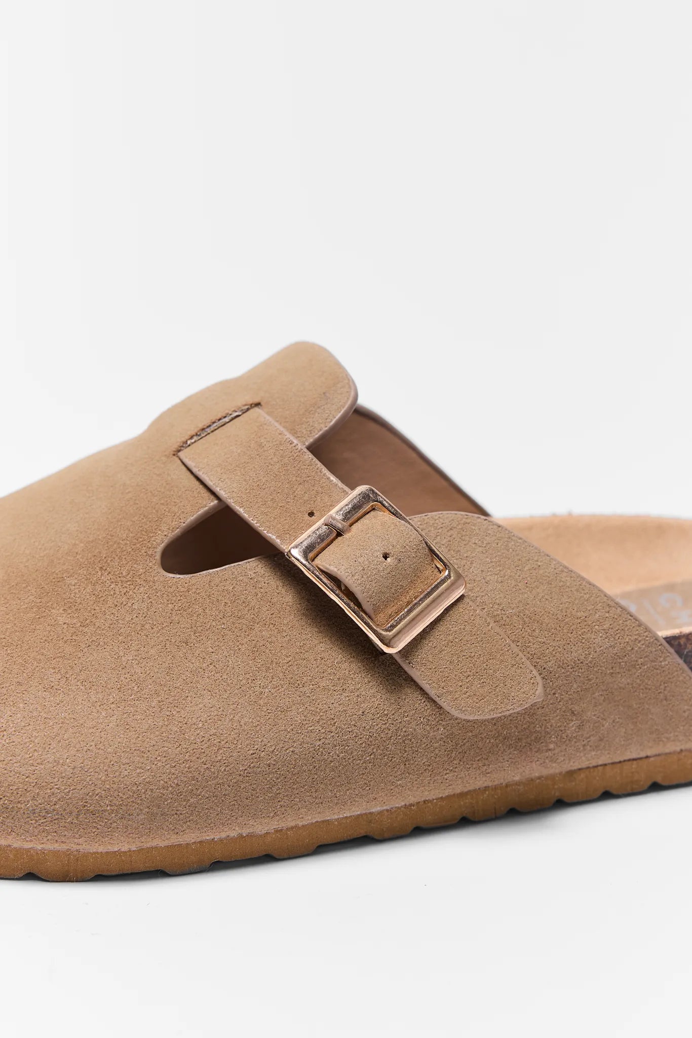 Tan suede sandal with a buckle on a white background Amelia Tan Faux Suede Mules