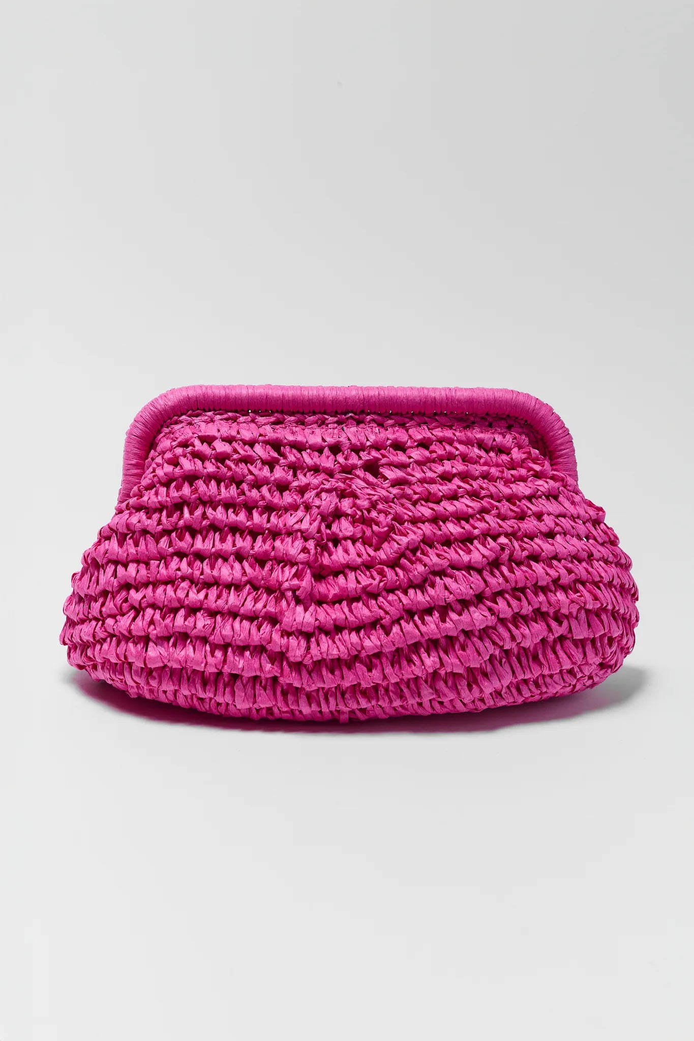Pink woven clutch bag on a light gray background