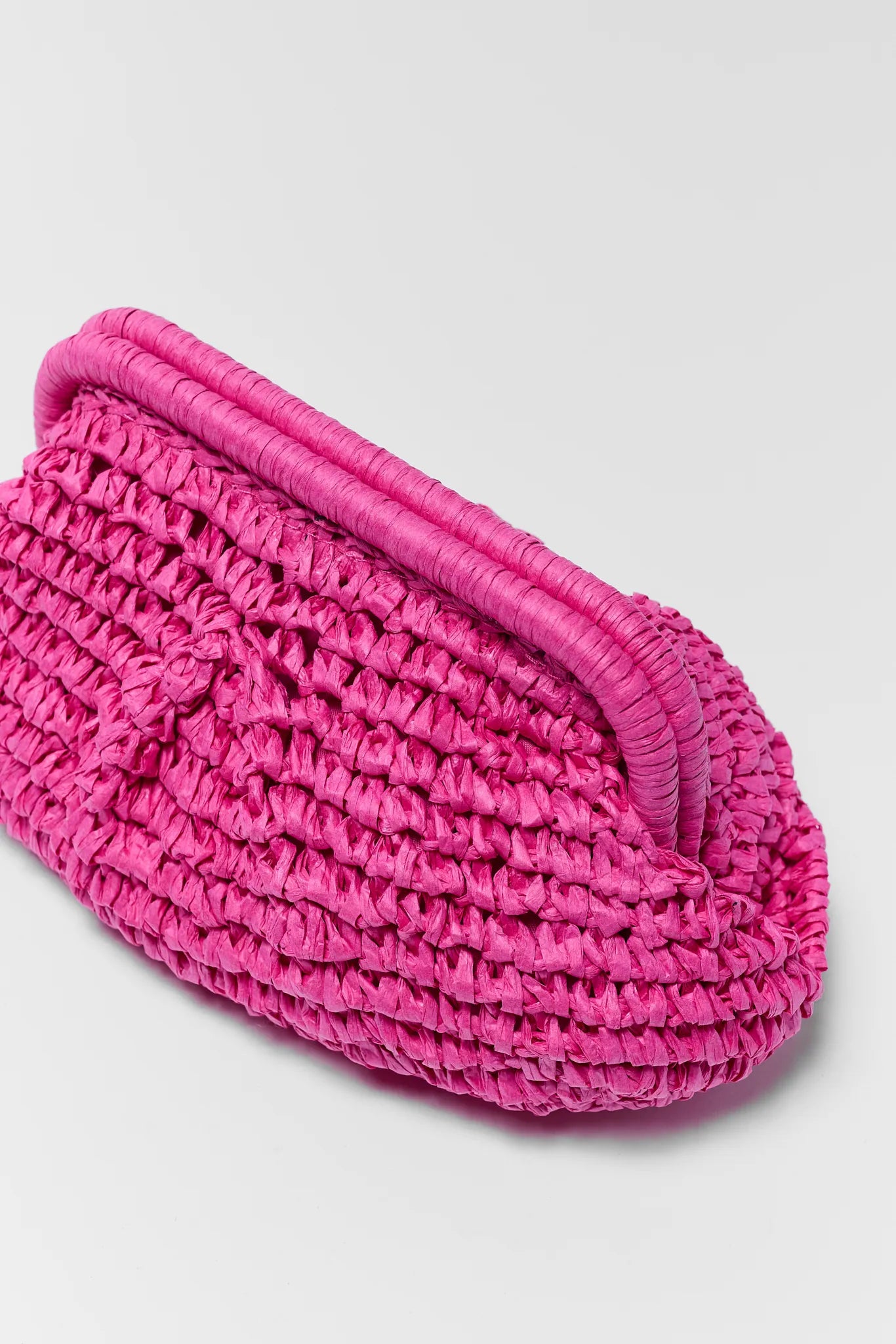 Pink woven shoe with a white background