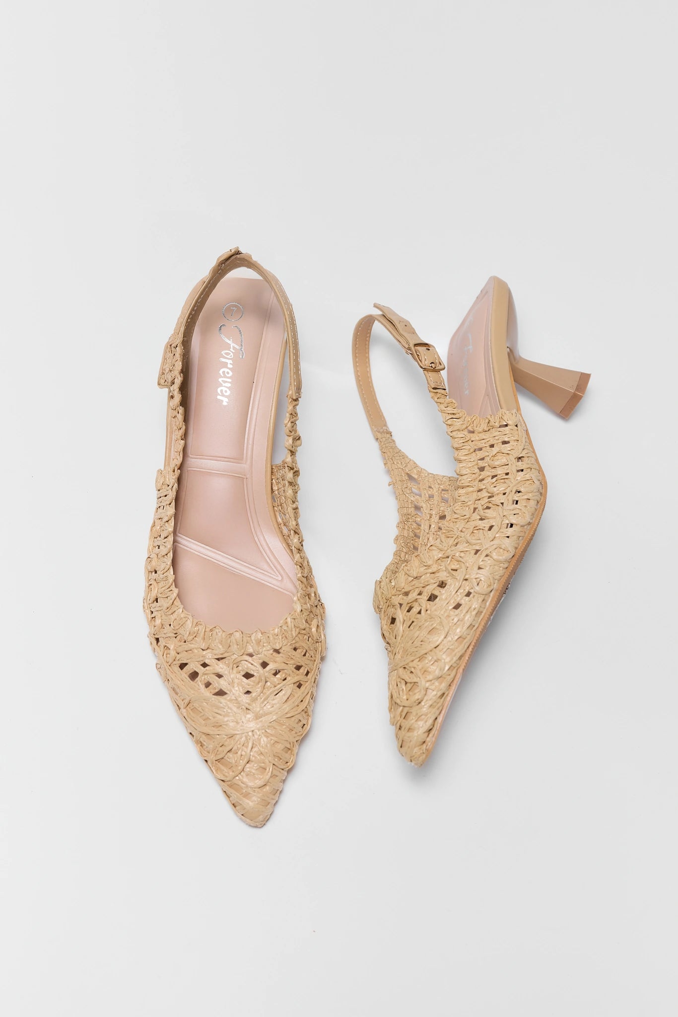 Pair of beige woven shoes on a light gray background