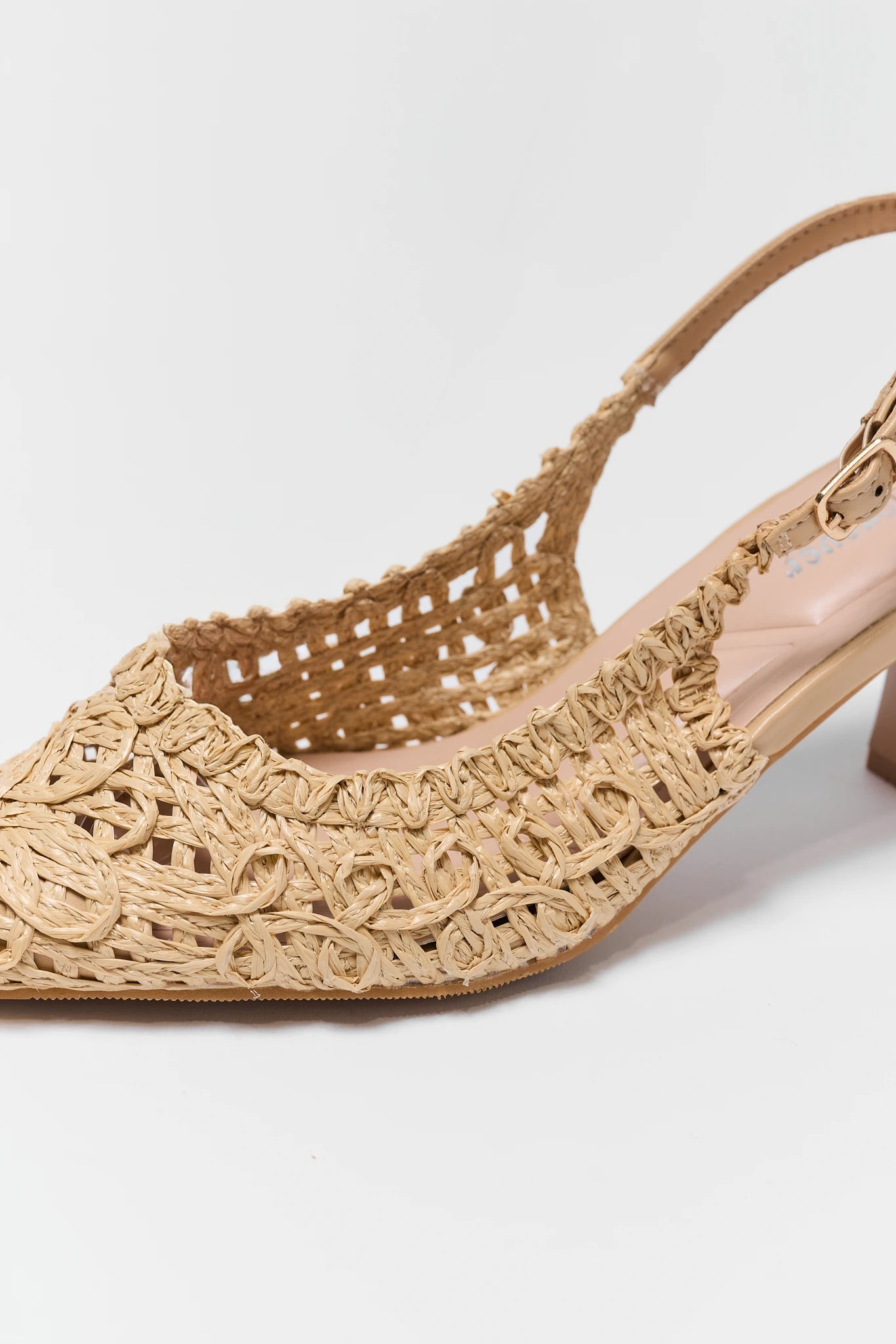 Beige sandal with woven design on a white background