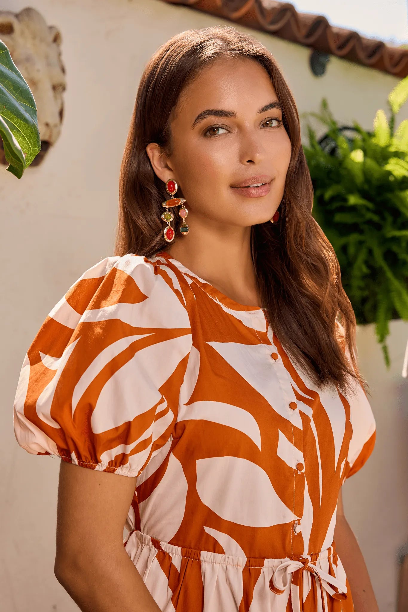 close up Woman wearing a brown and white patterned dress outdoors