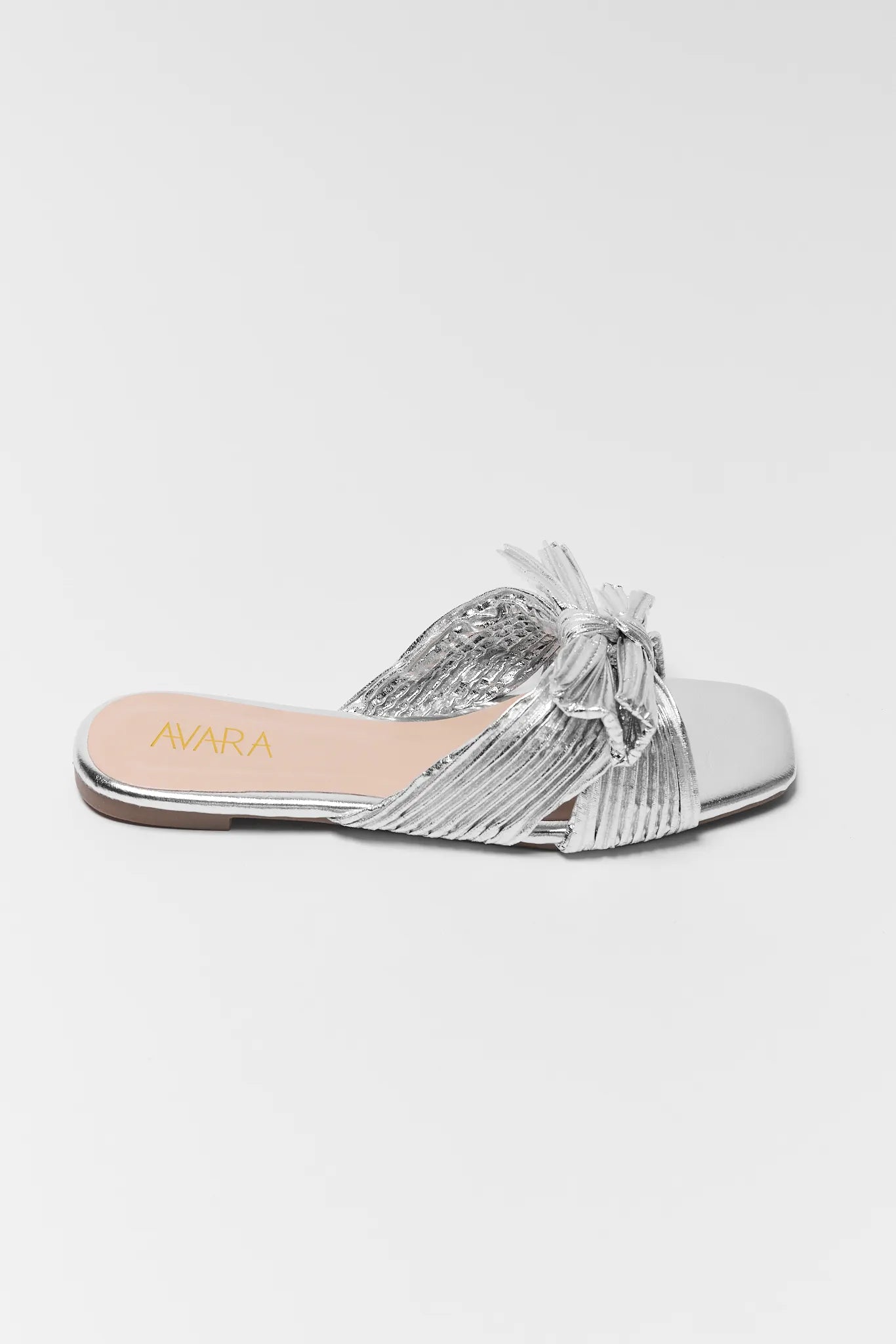 Silver sandal with a bow on a white background