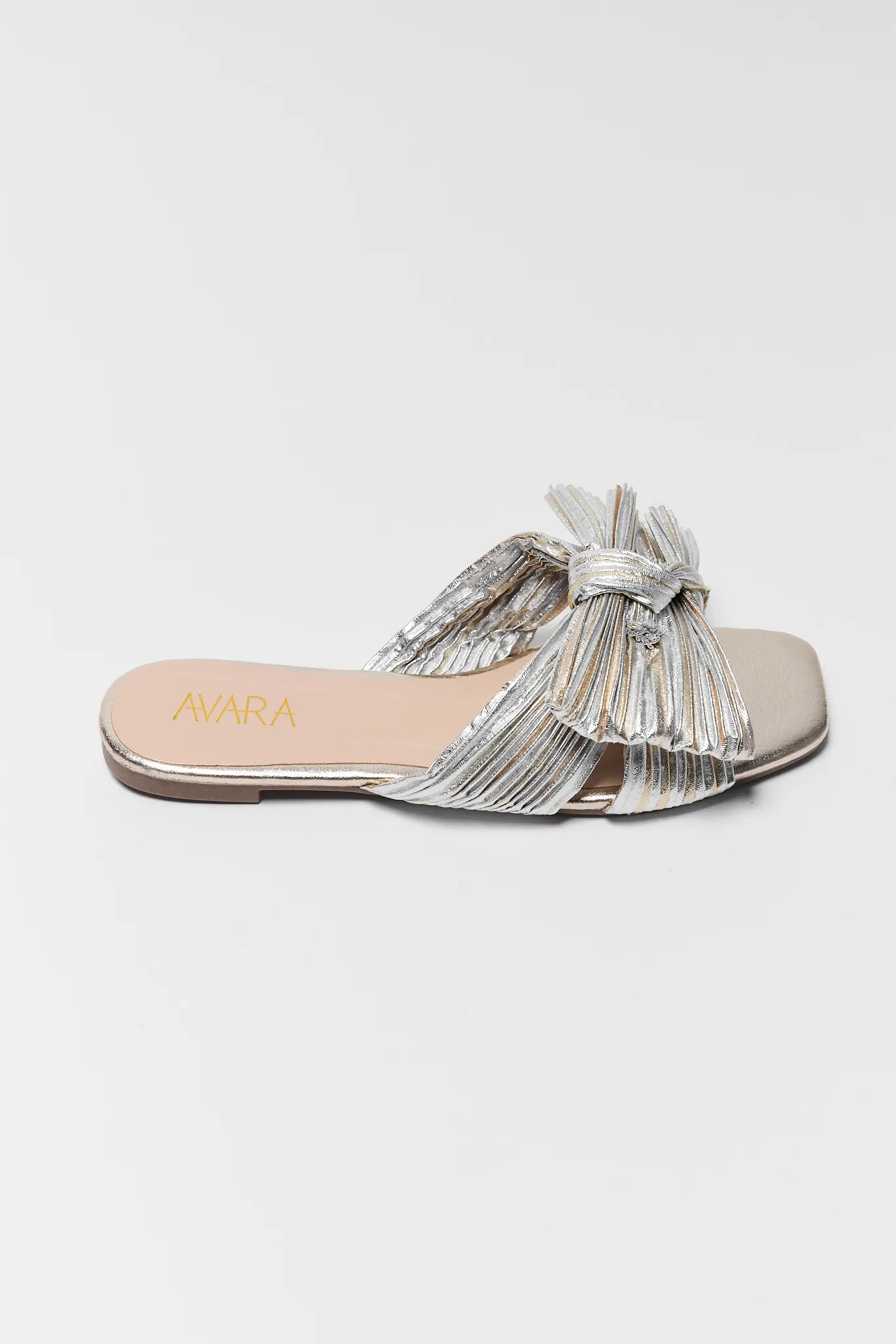 Silver sandal with decorative bow on a white background