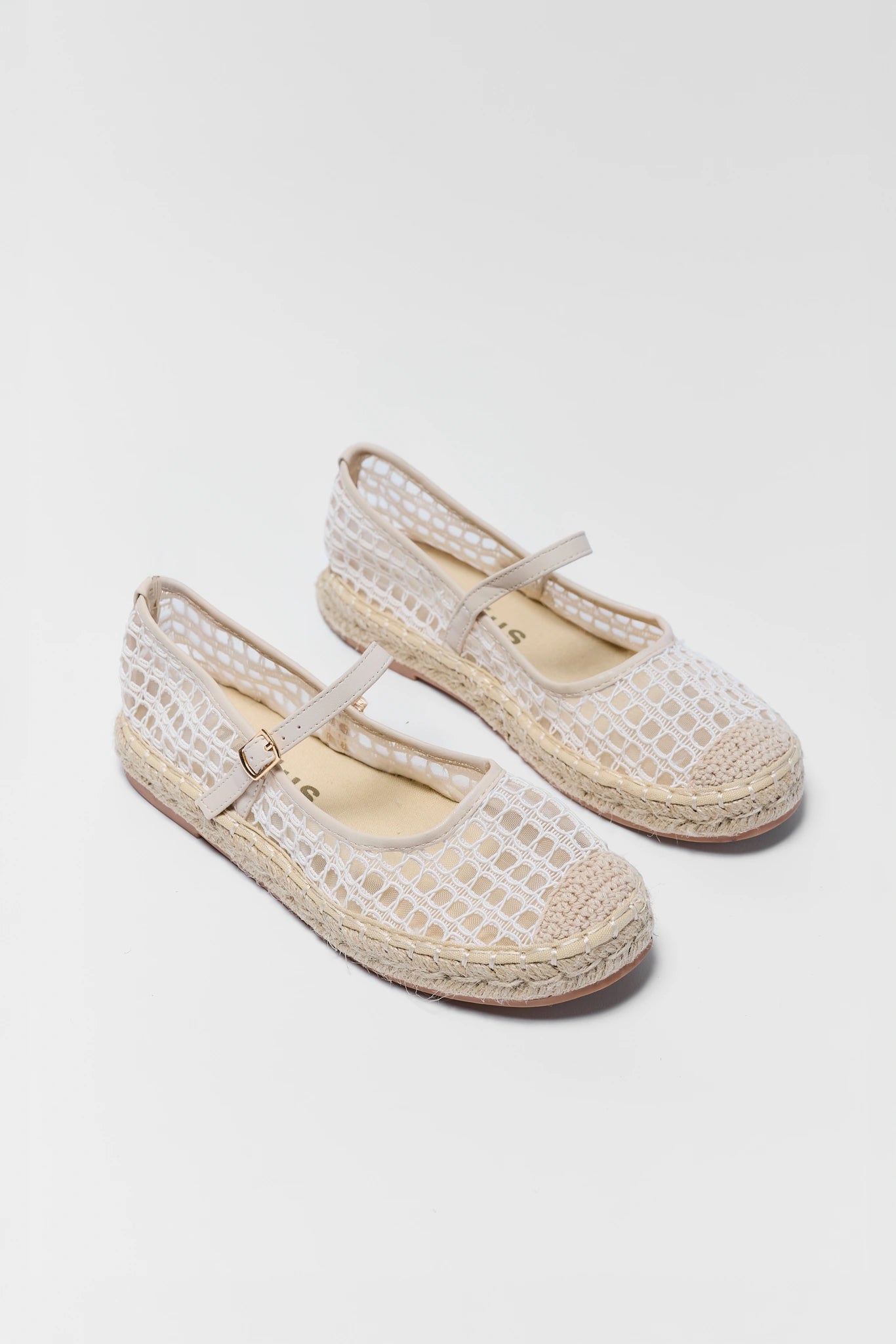 two Pair of white woven shoes with jute sole on a light gray background