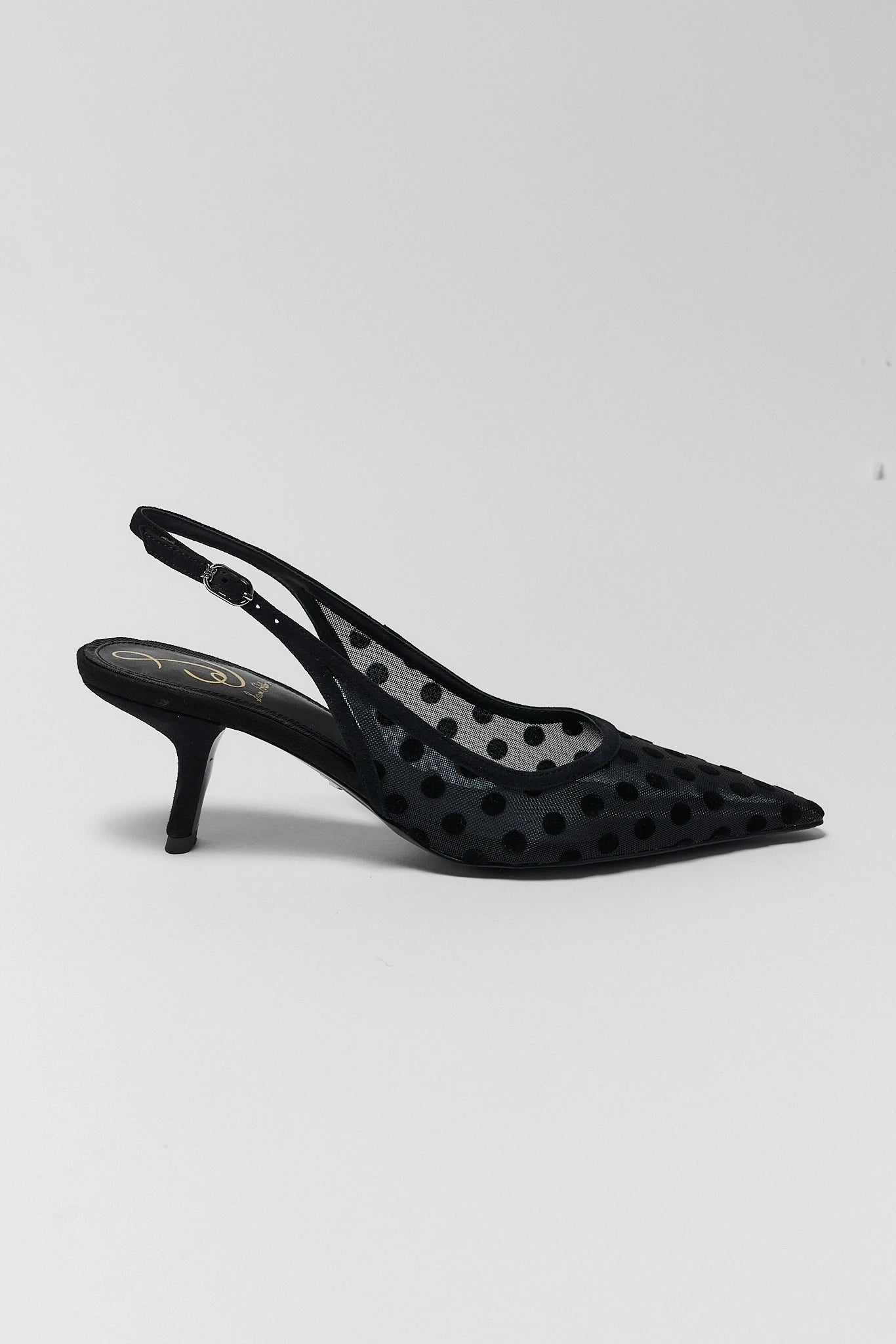 Black high-heeled shoe with a clear polka dot overlay on a white background