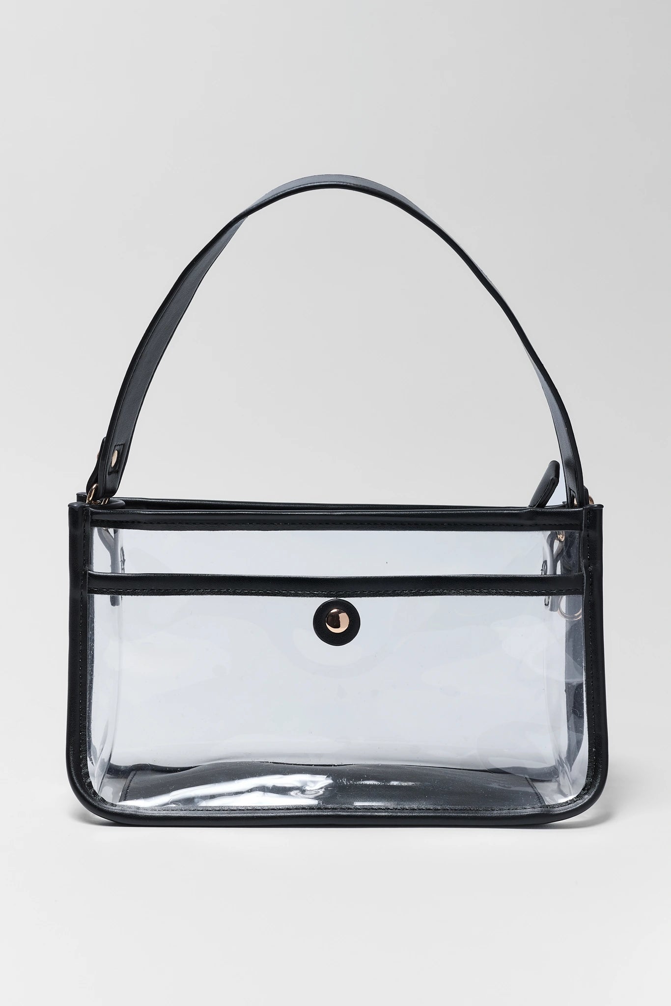 A clear plastic handbag with black trim, a black shoulder strap, and a small black circular logo on the front, set against a light gray background.
