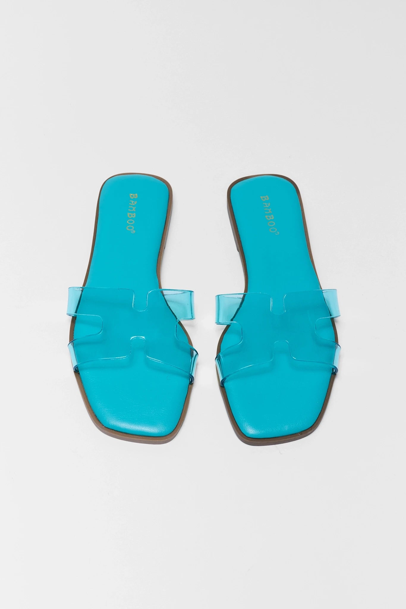 two Pair of turquoise sandals on a gray background