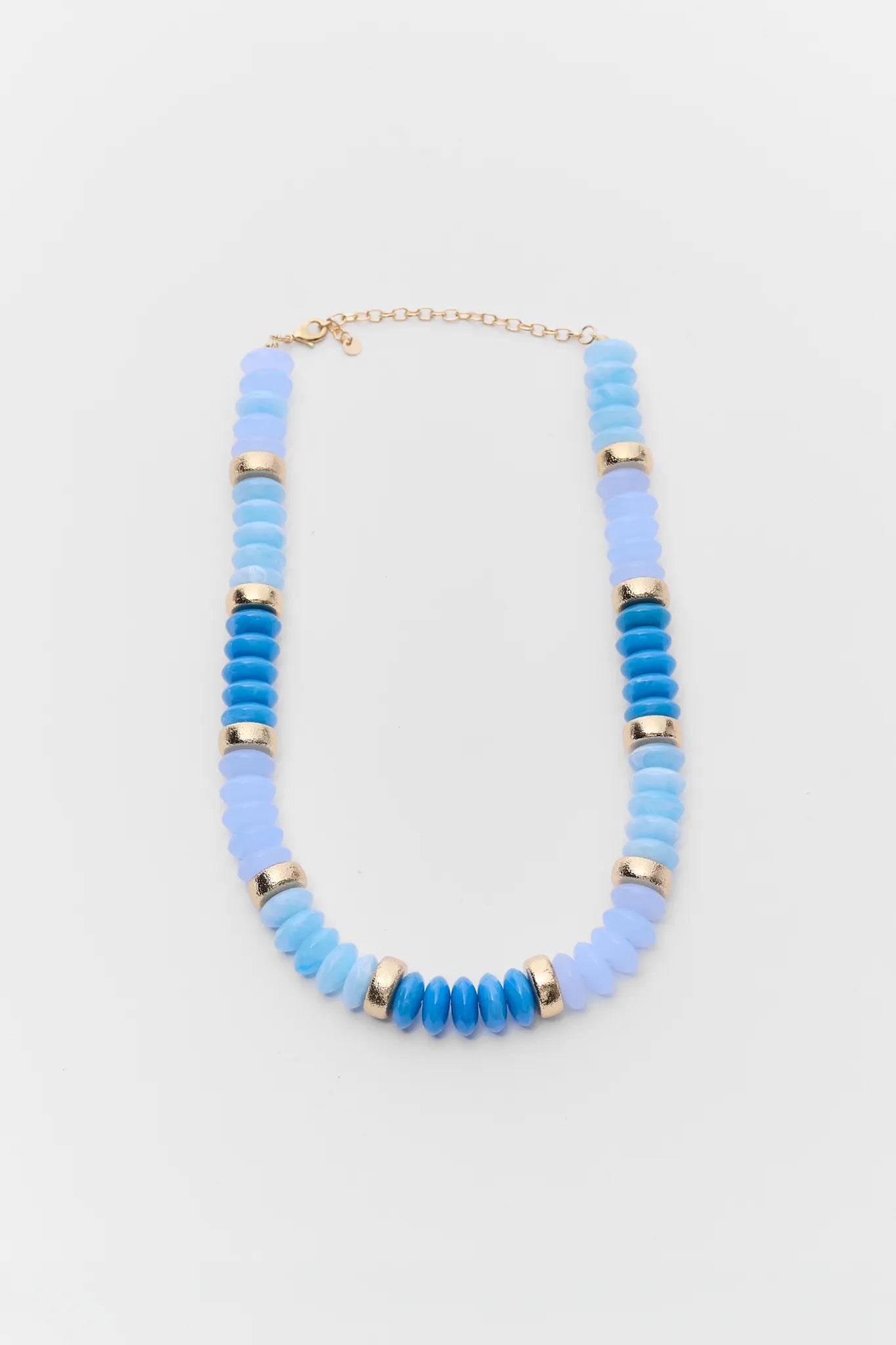 Necklace with blue beaded design on a light gray background