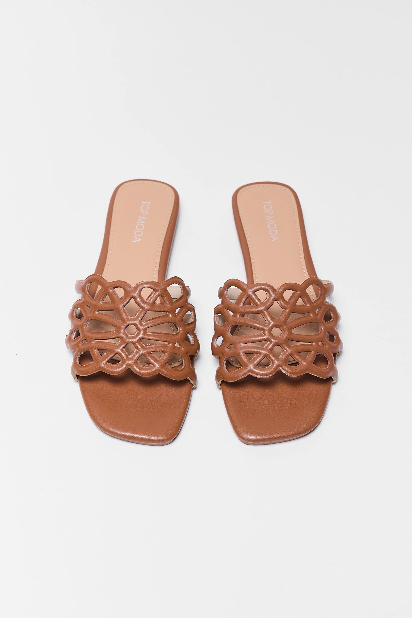 Pair of two brown sandals with intricate cut-out design on a white background