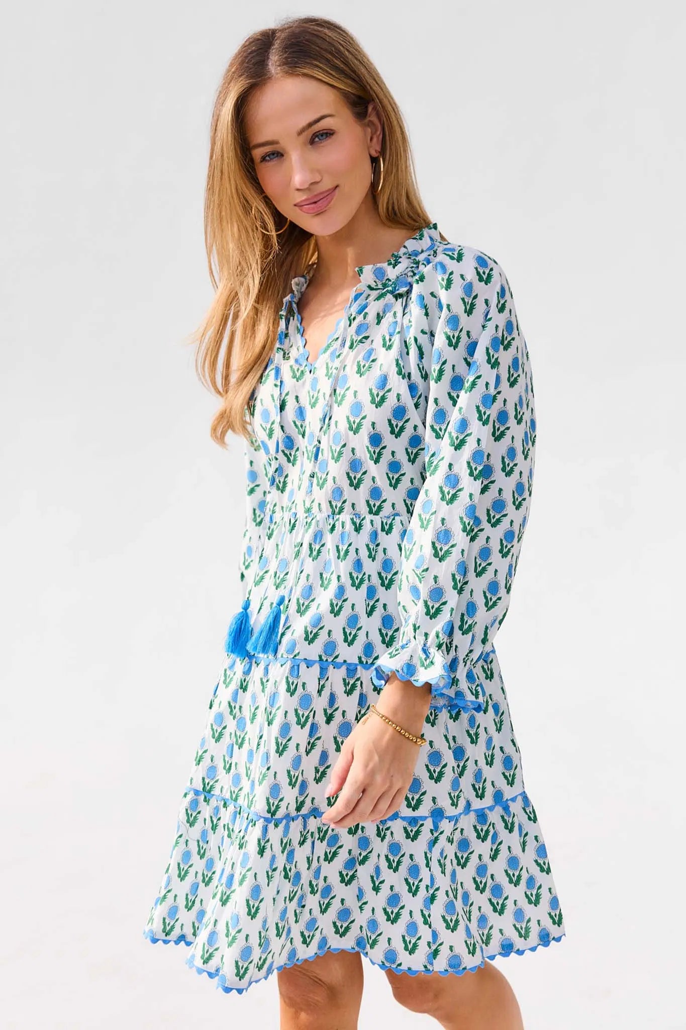 Woman wearing a blue floral dress on a white background