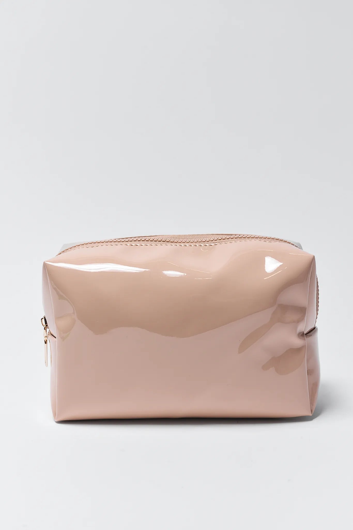 Beige patent leather pouch on a light gray background
