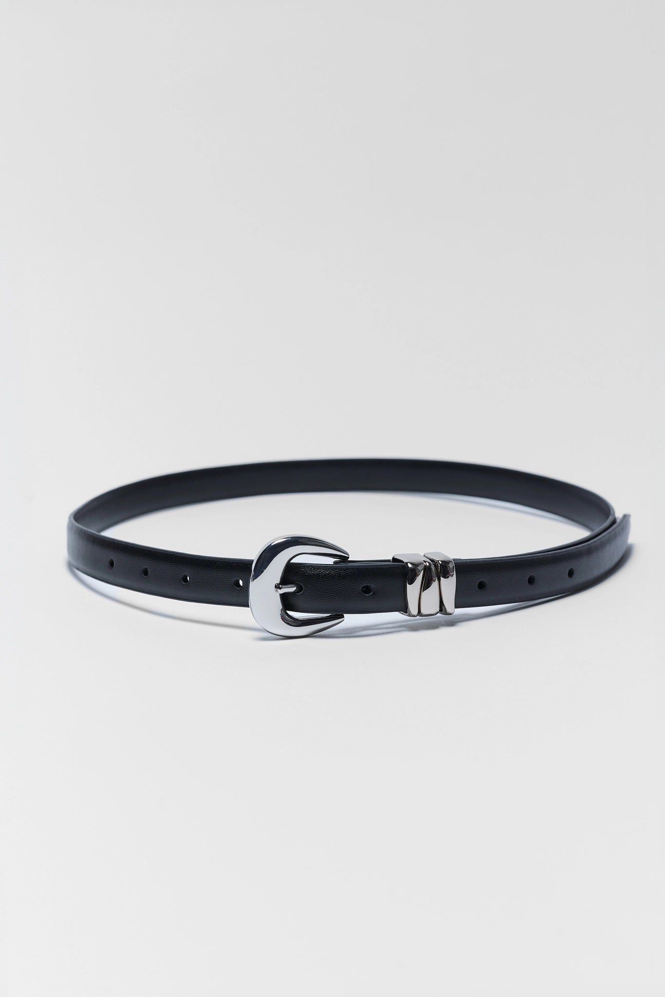 A black leather belt with a polished silver-tone buckle, displayed in a curved shape on a light gray background.