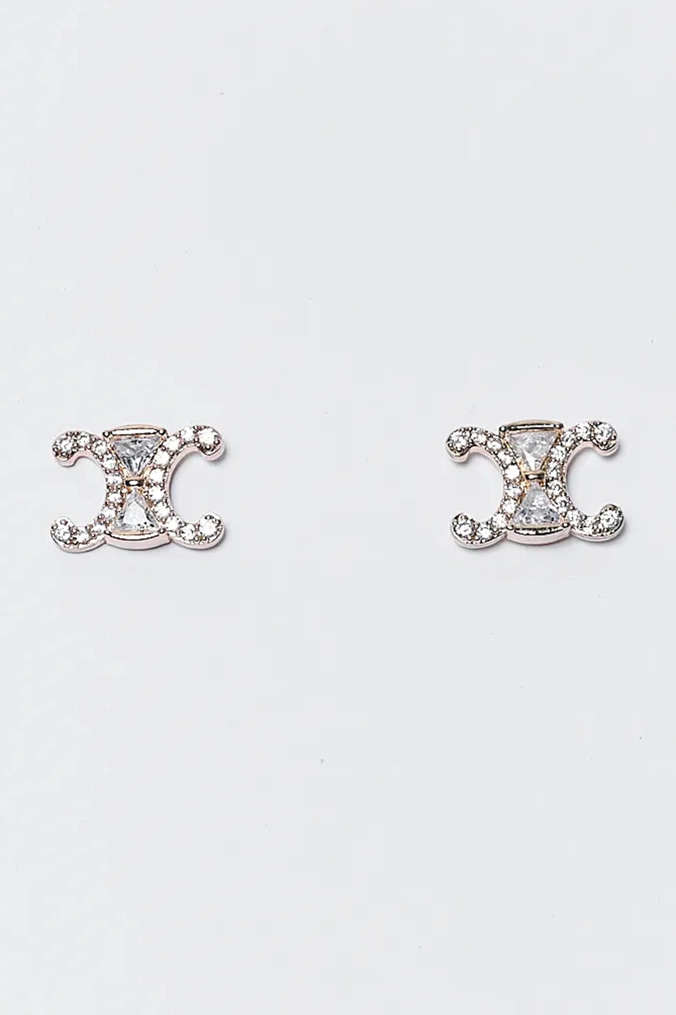 Pair of silver earrings with a decorative design on a white background