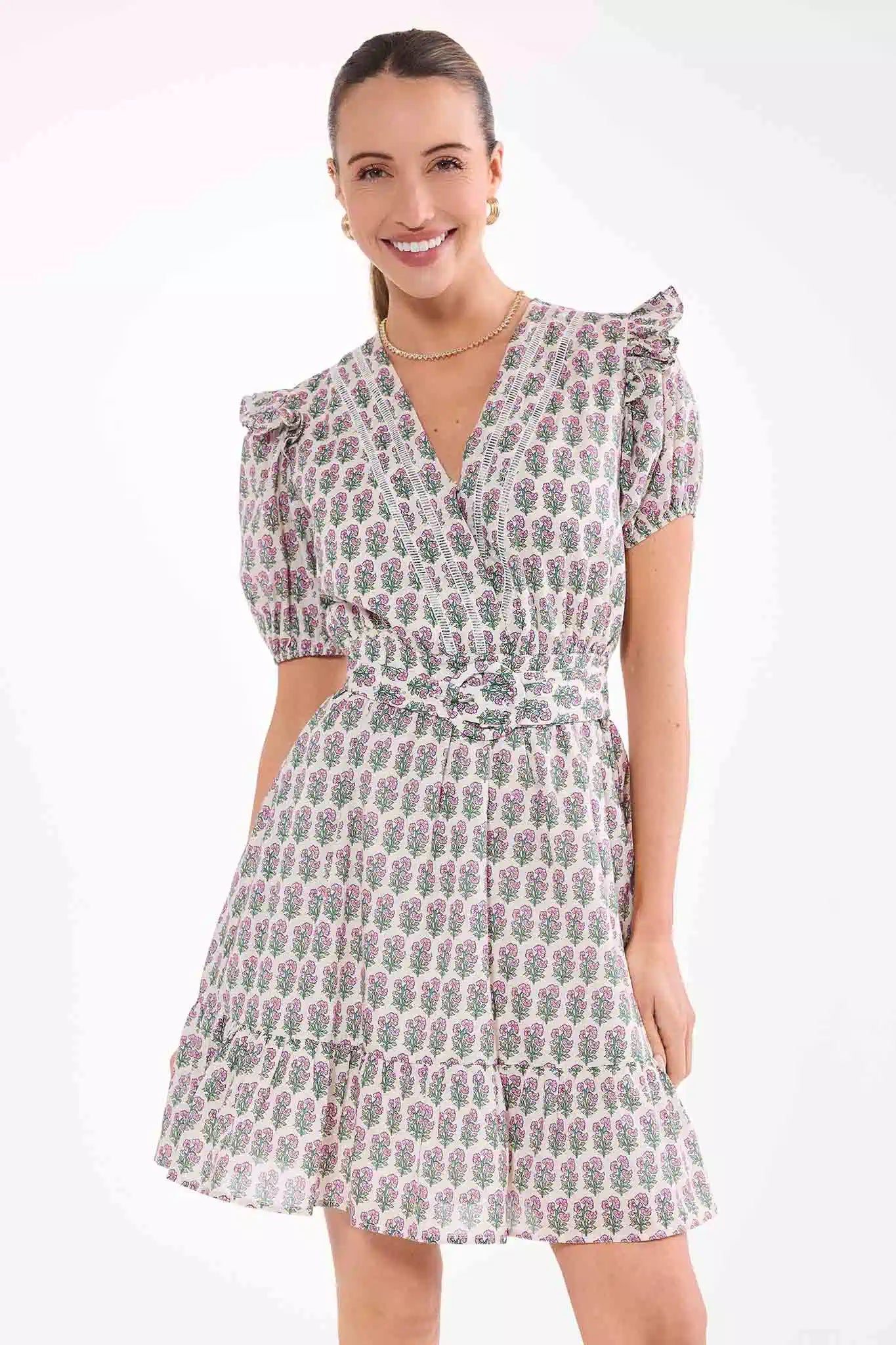 Woman wearing a patterned dress on a white background