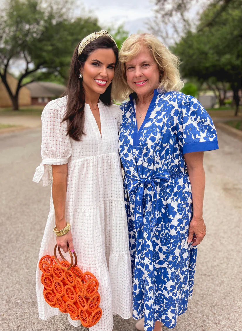 two woman wearing dresses with blurred background