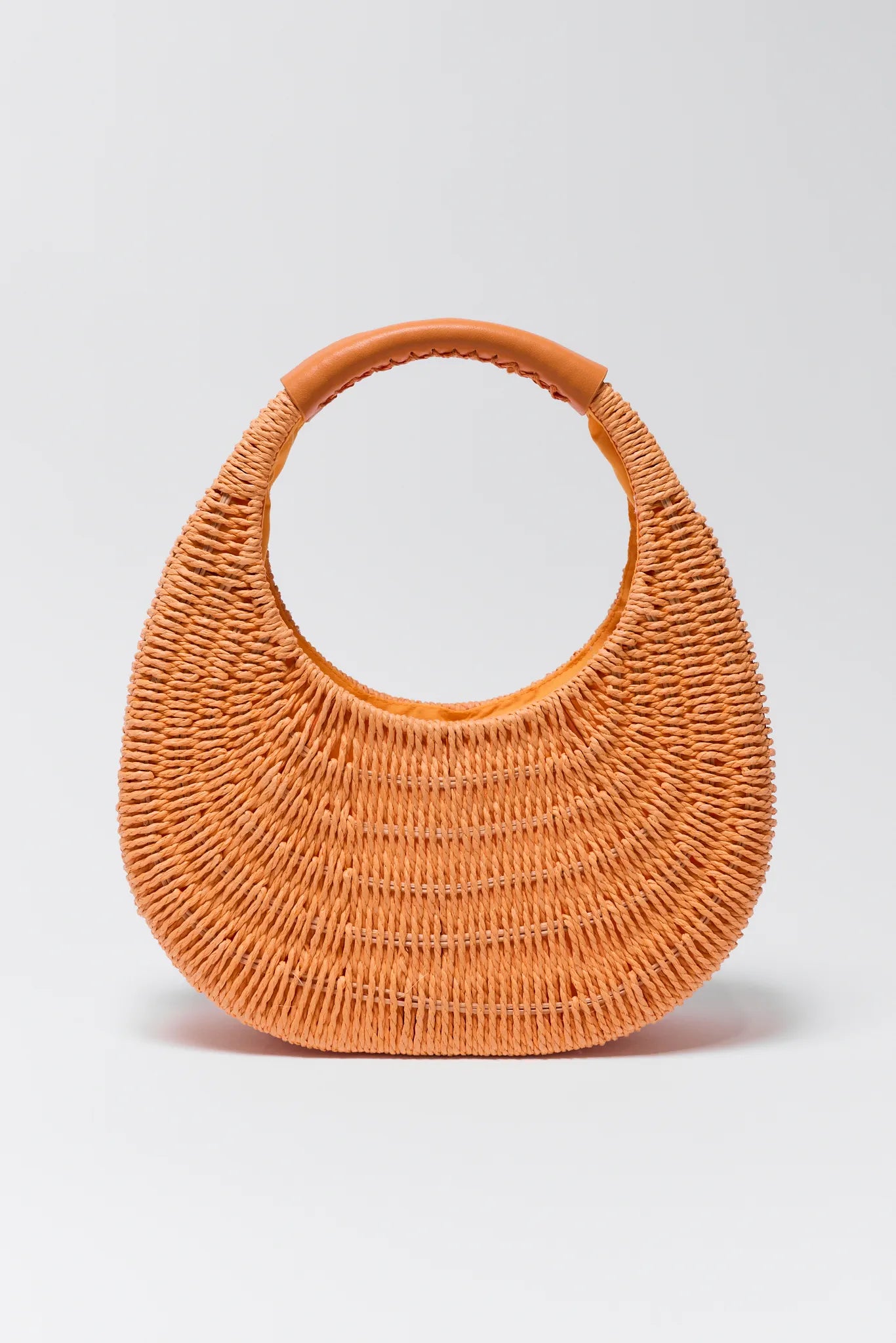 Orange woven handbag on a light gray background