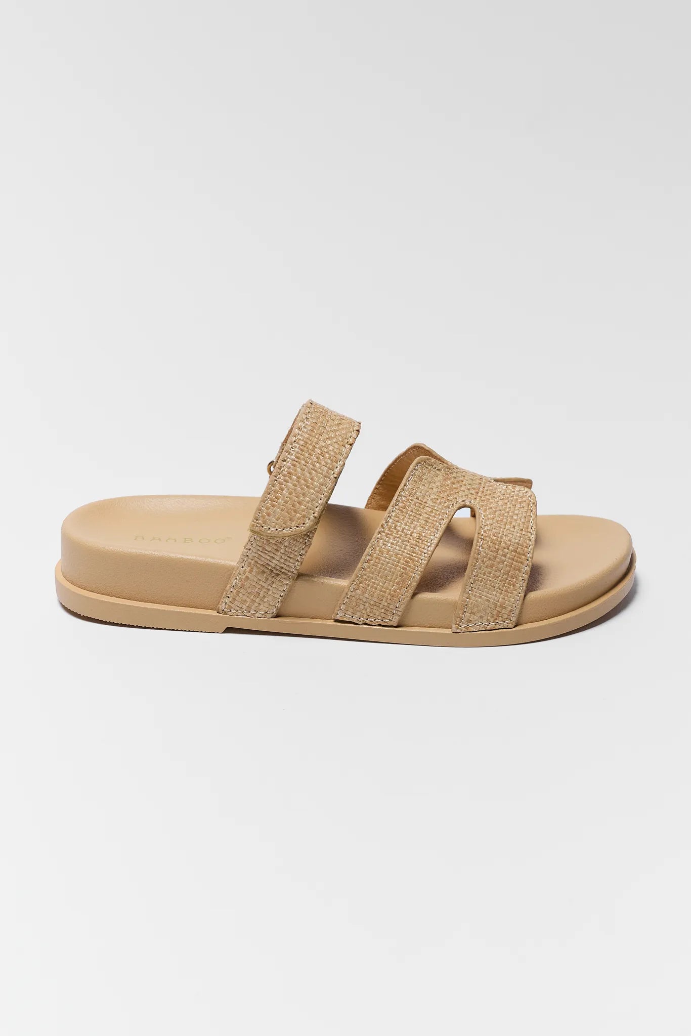 Beige sandal with two straps on a white background