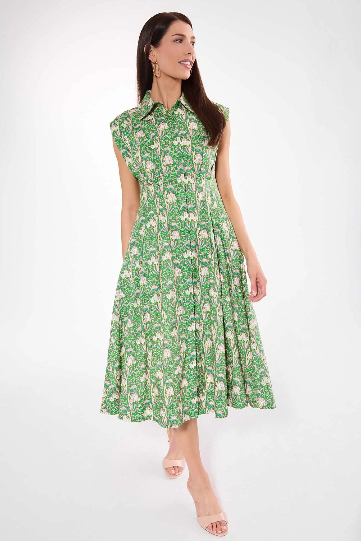 Woman wearing a green floral dress on a white background