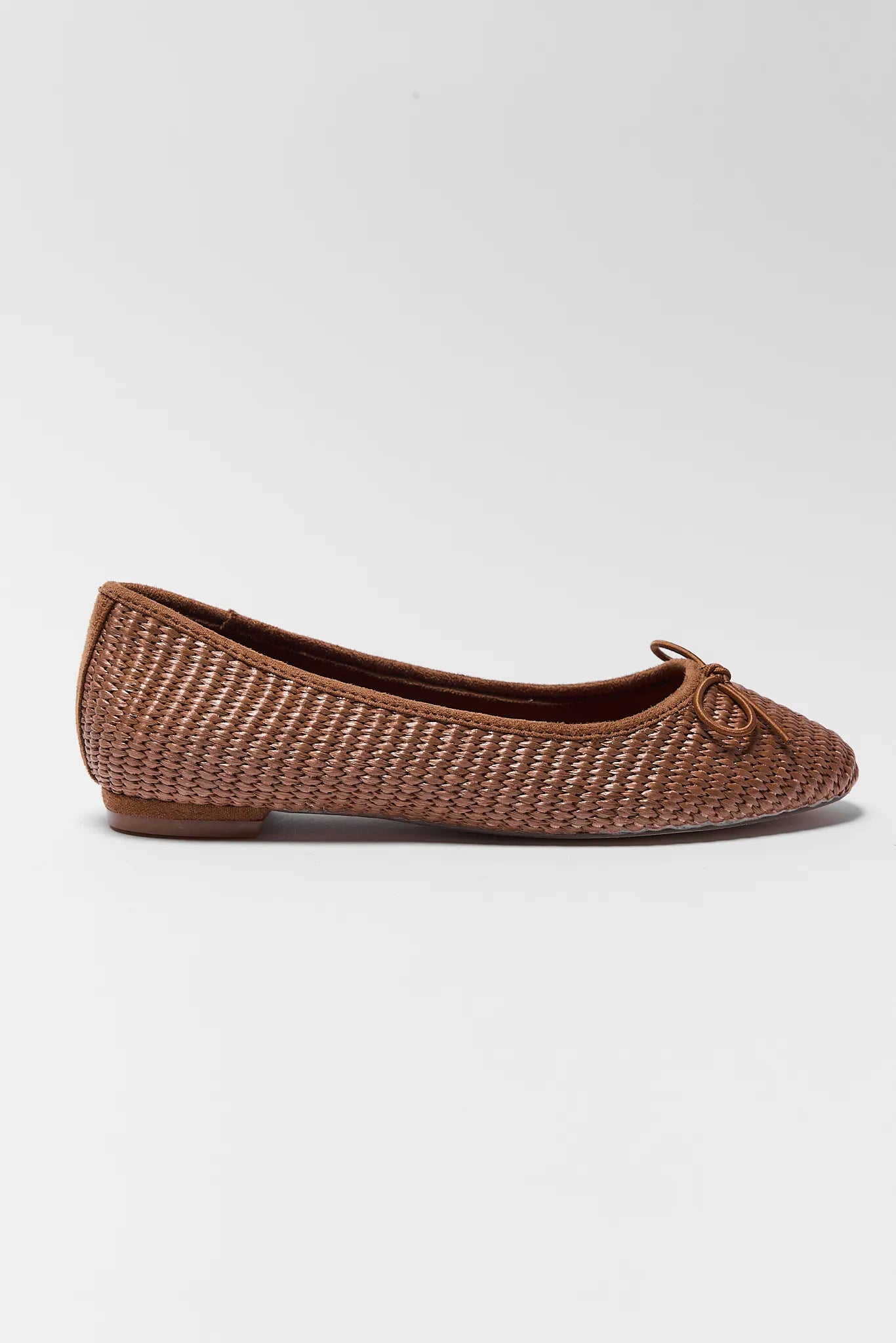 Brown woven flat shoe on a white background