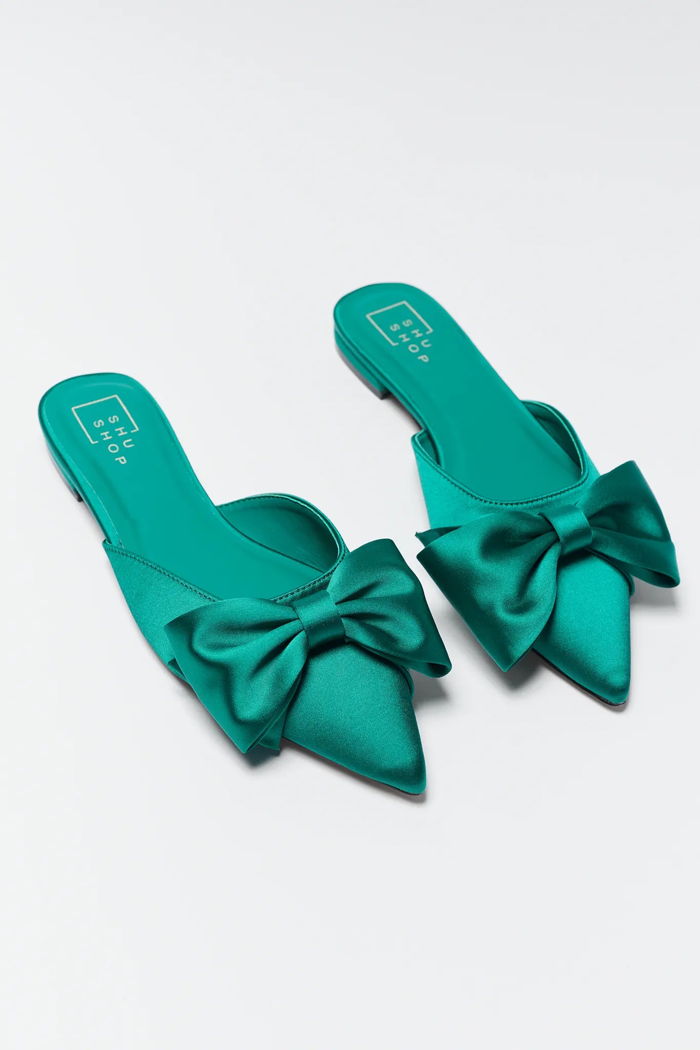 Teal Dottie Pointed Toe Bow Flats on a light gray background