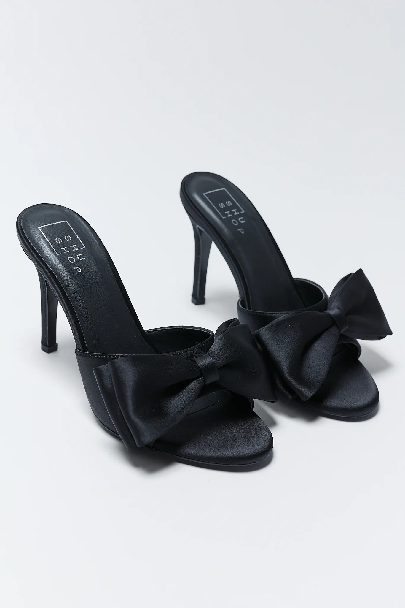 Elena Black Bow Heels with bow details on a light gray background