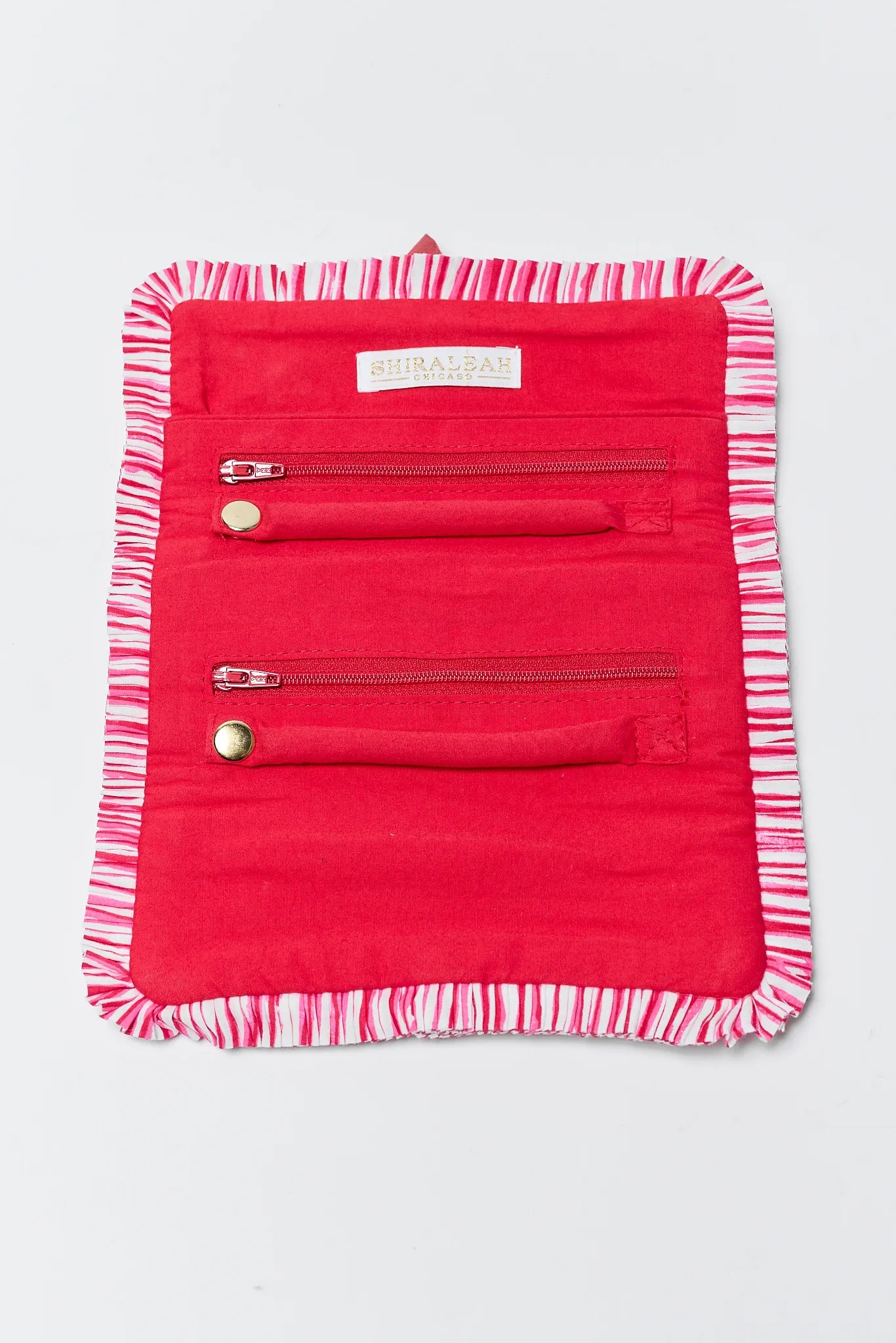 Red travel organizer with striped trim on a white background