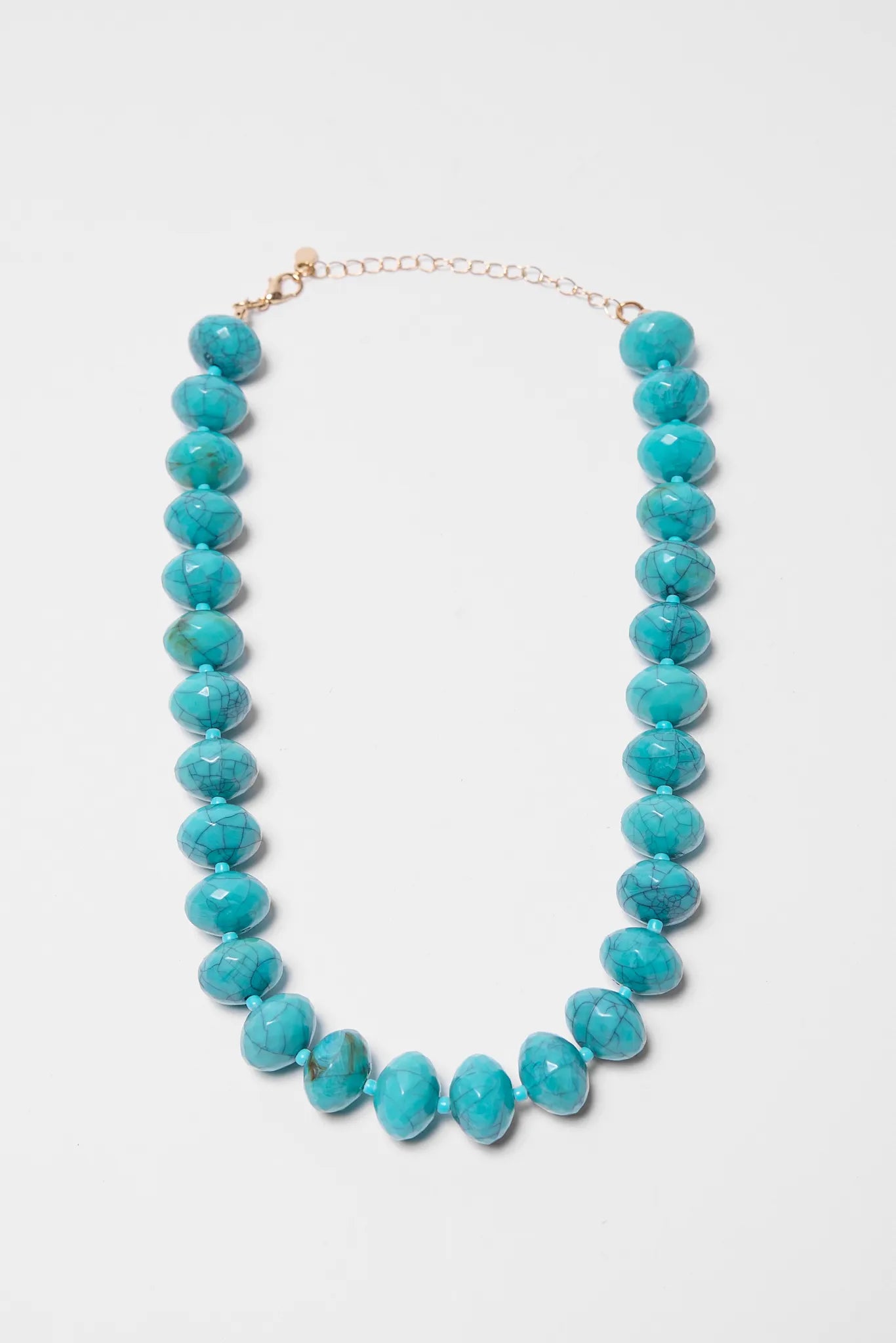Turquoise beaded necklace on a light gray background