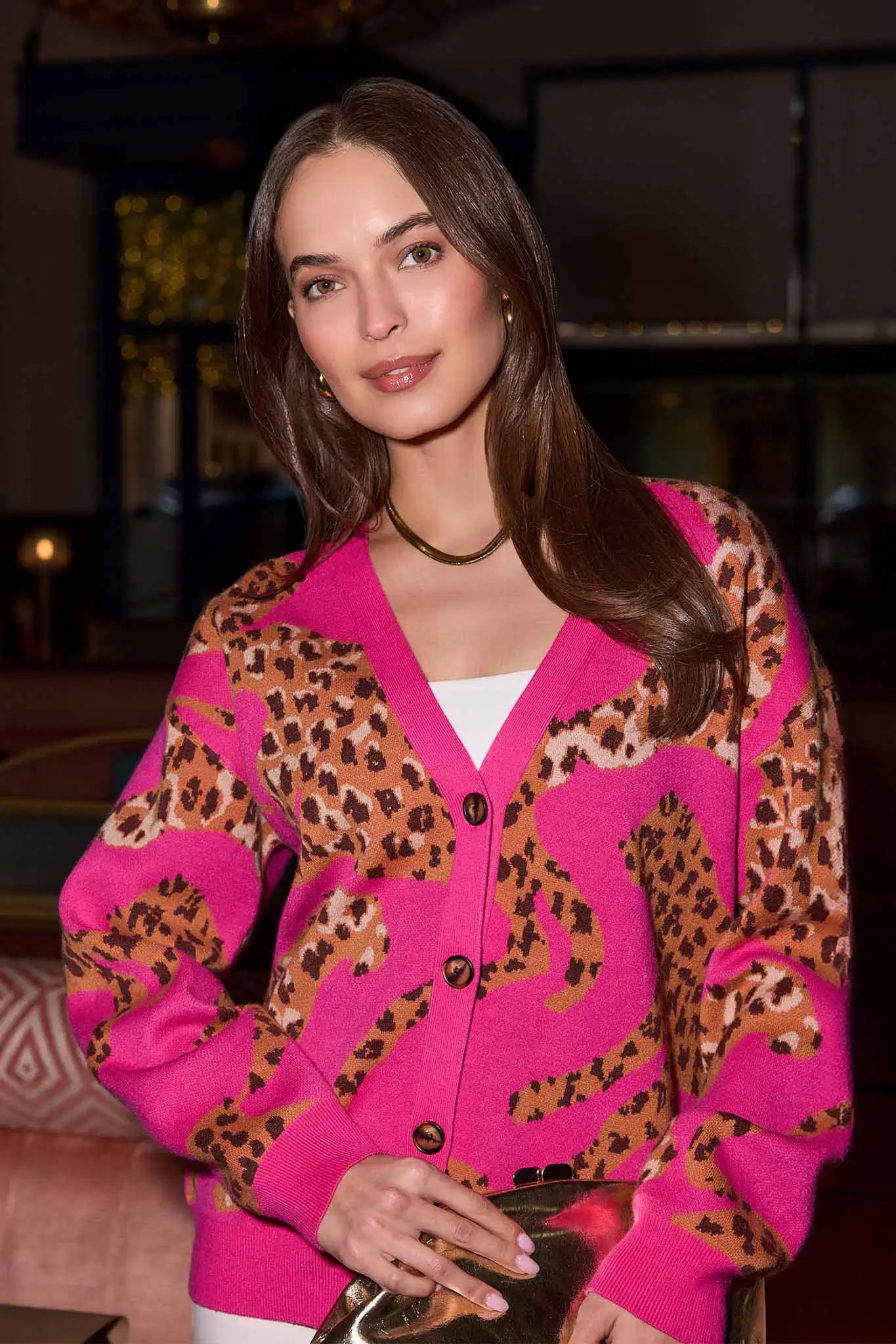 woman wearing a pink leopard print cardigan