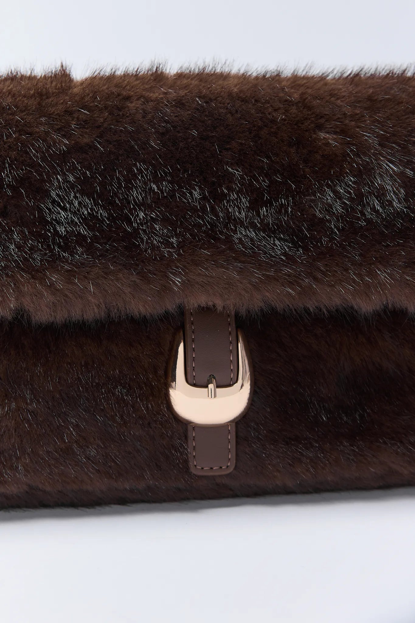 Brown fur Gloria Bag with a gold buckle on a white background