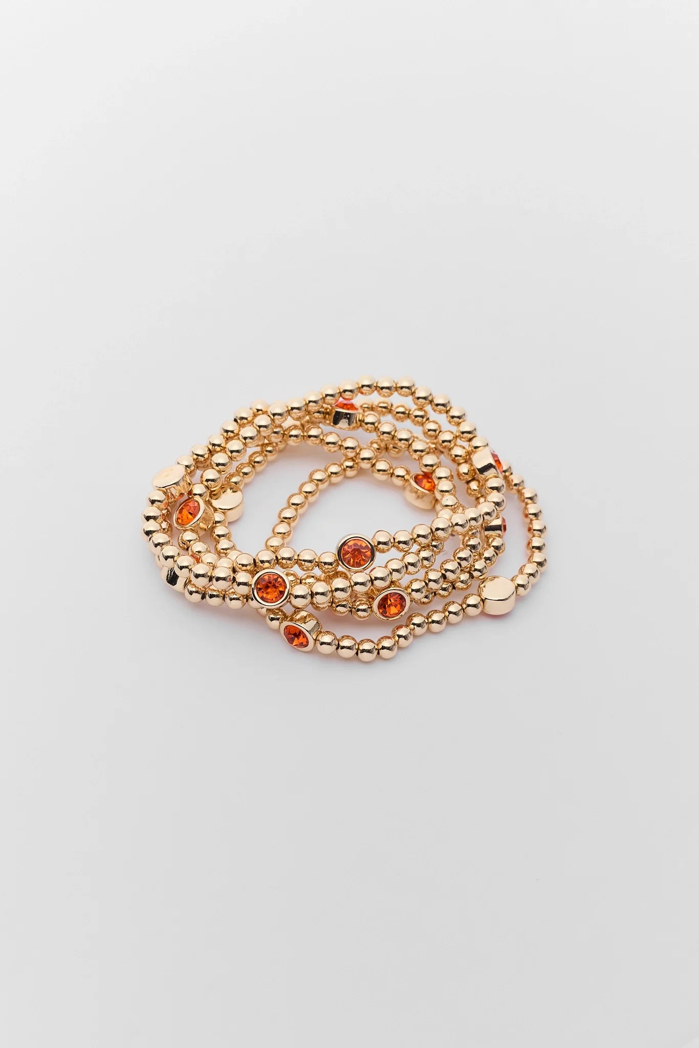 Gold Beaded orange Rhinestone Bracelet on a white background