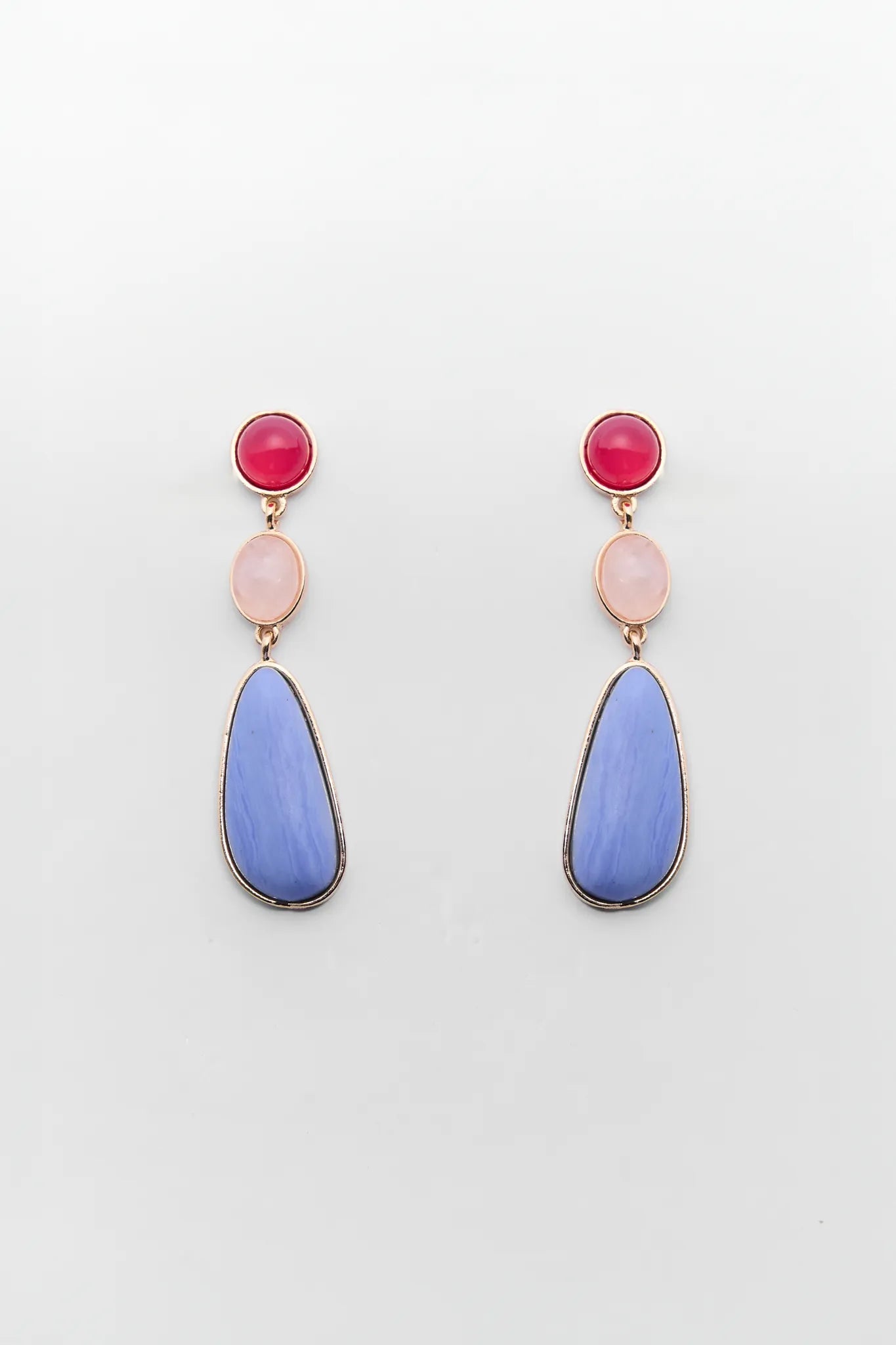 Pair of earrings with pink and blue stones on a white background