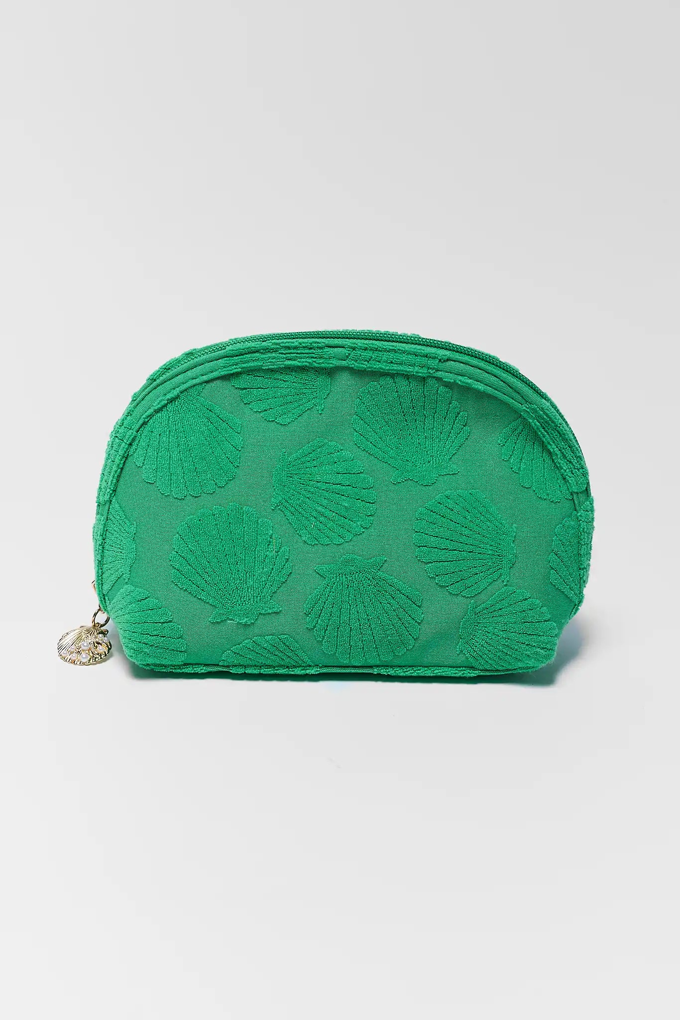 Green textured pouch with shell pattern on a light gray background