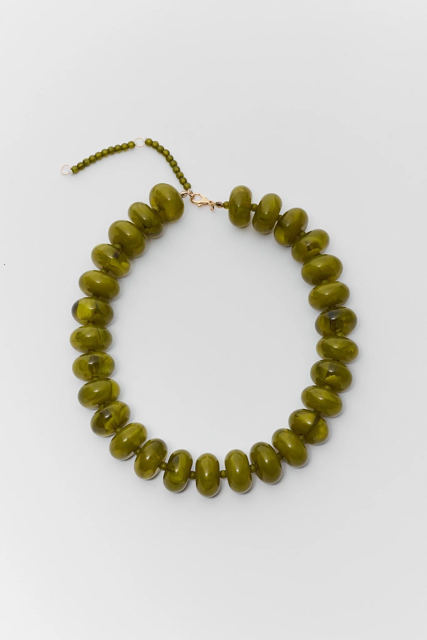 An olive green beaded necklace with chunky, rounded disc-shaped beads and a small gold clasp, displayed on a clean white background.