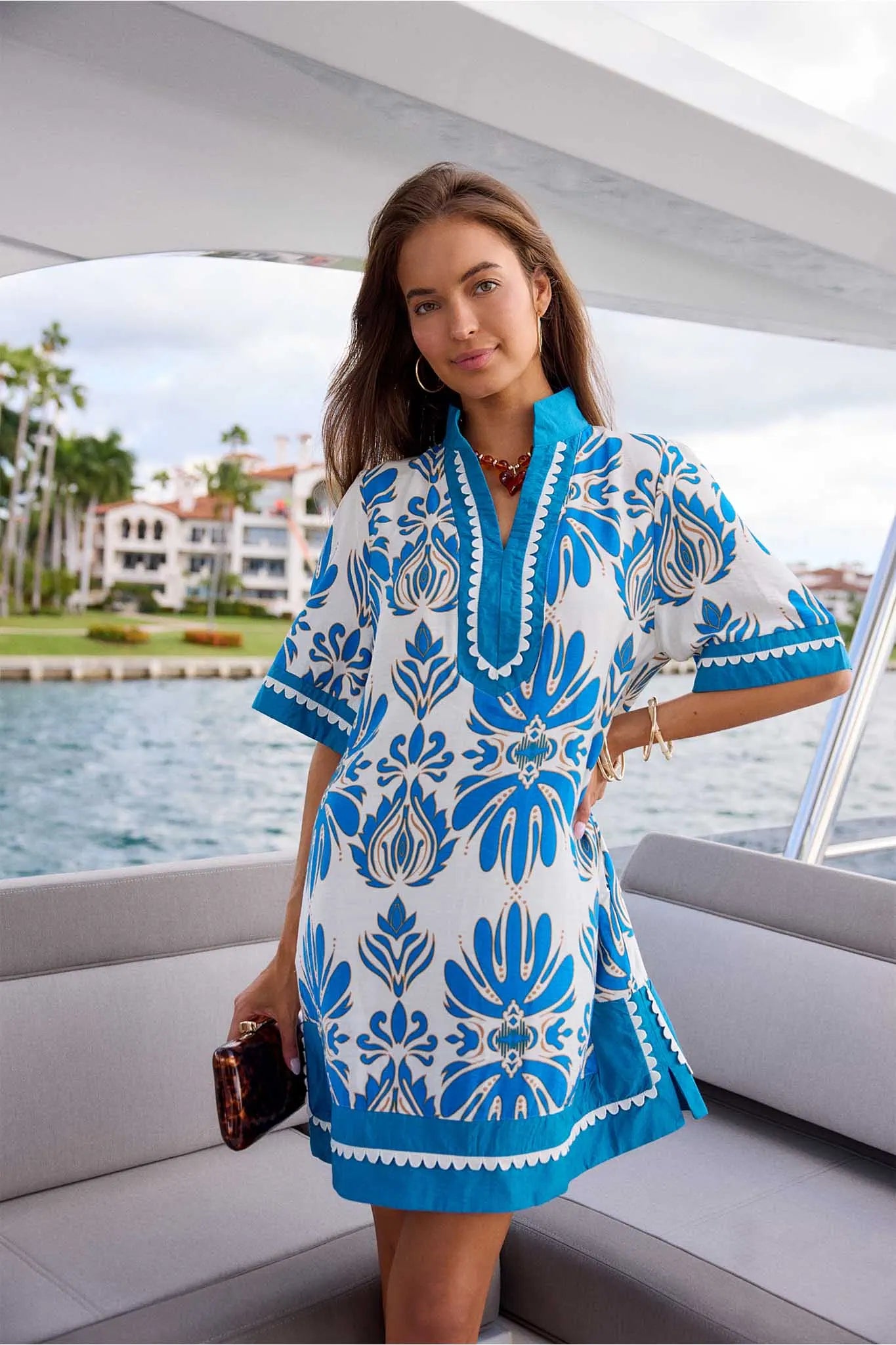 Woman wearing a blue and white patterned dress on a boat
