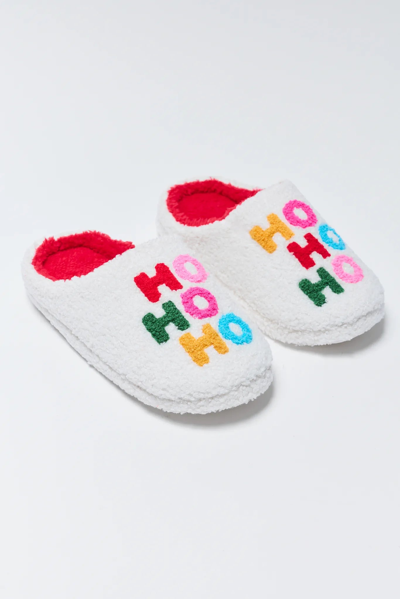 White slippers with colorful 'HO HO HO' text on a white background