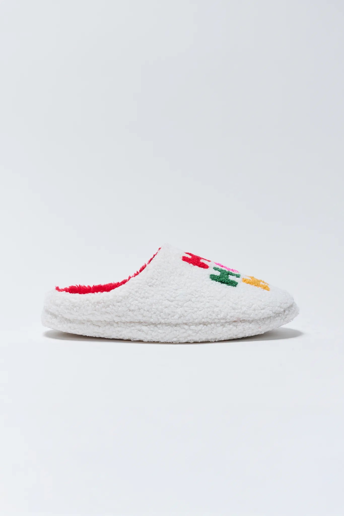 White slipper with colorful accents on a light gray background