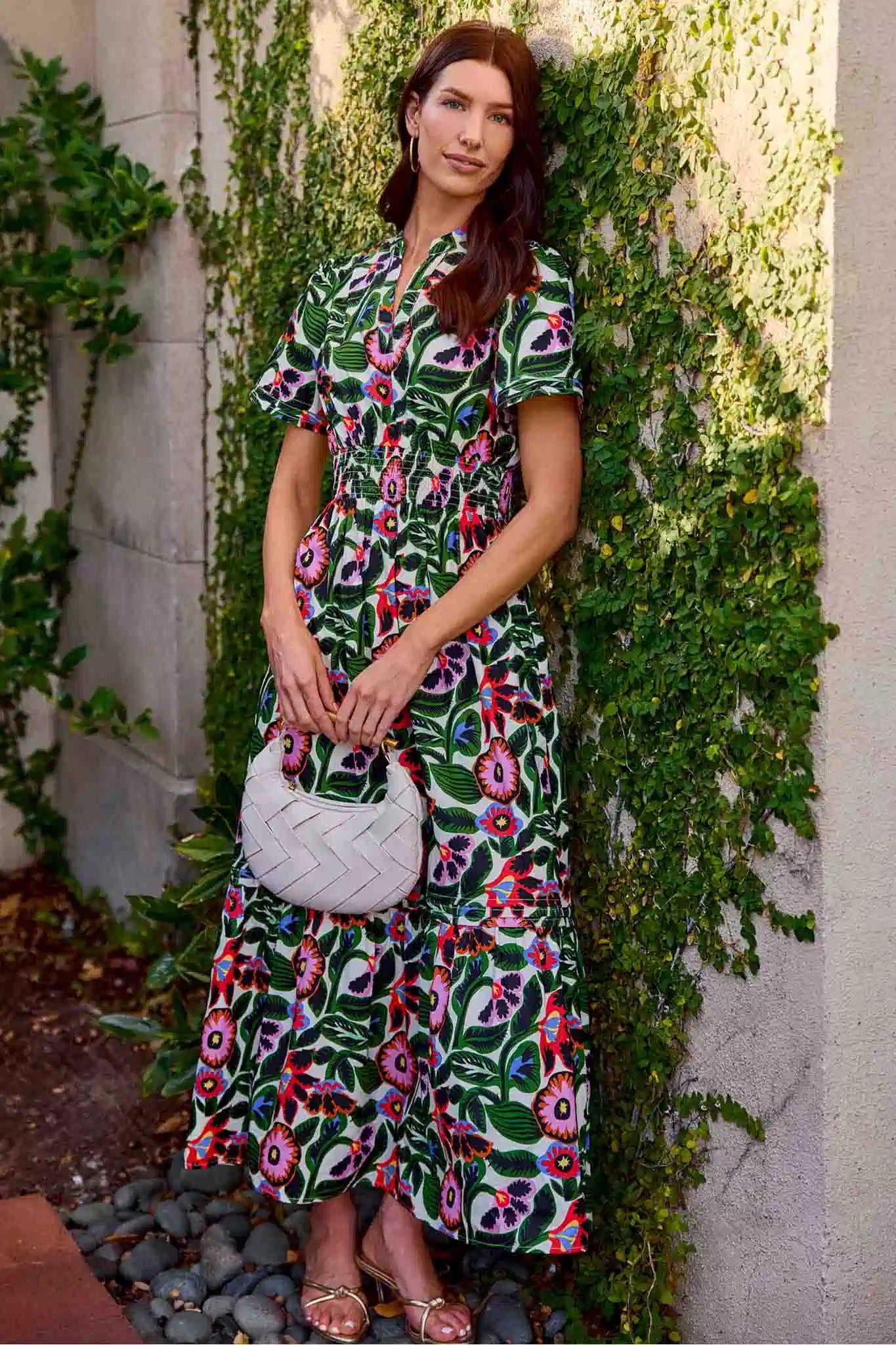 woman wearing a long floral dress with green background
