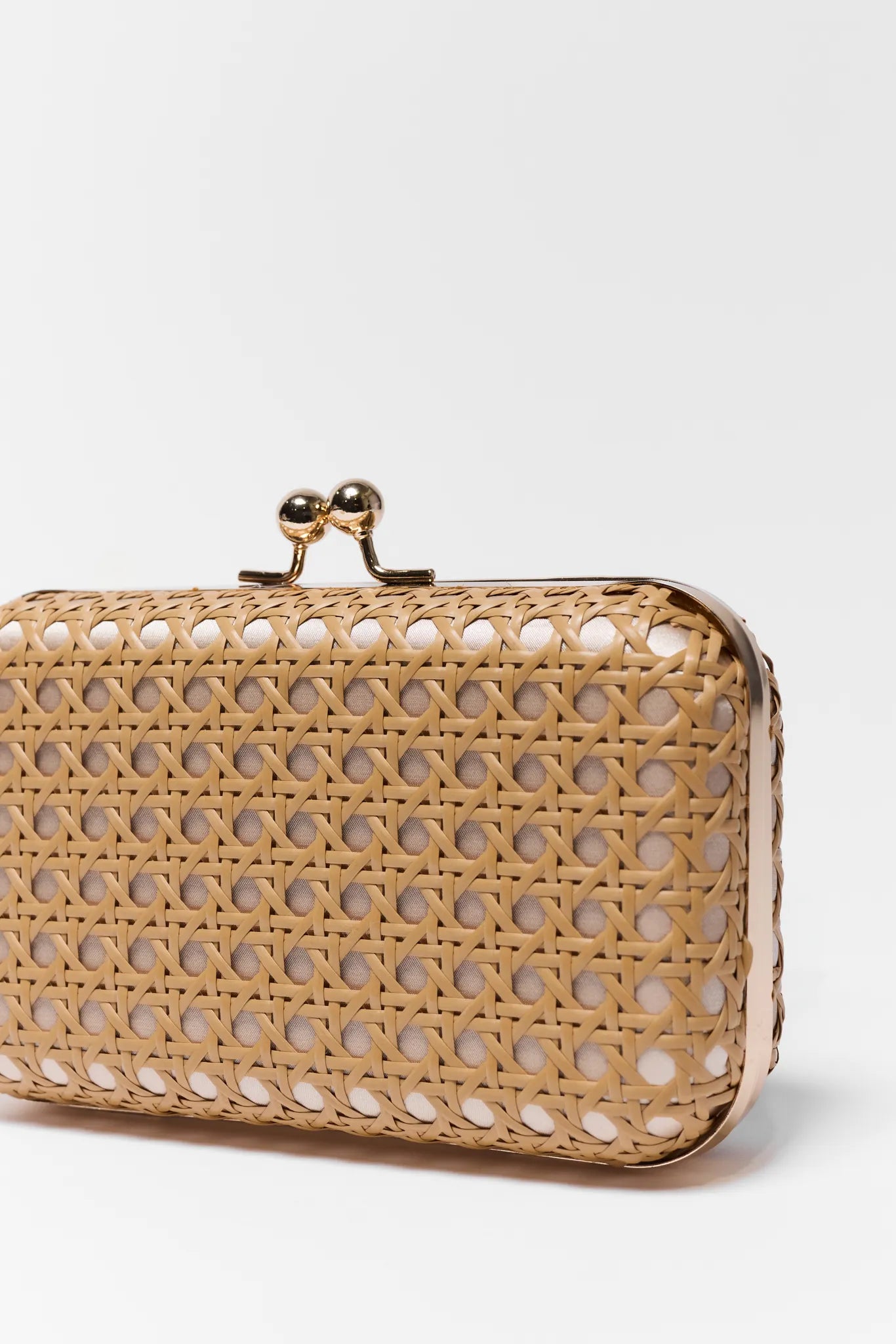 Woven clutch bag with a gold clasp on a white background