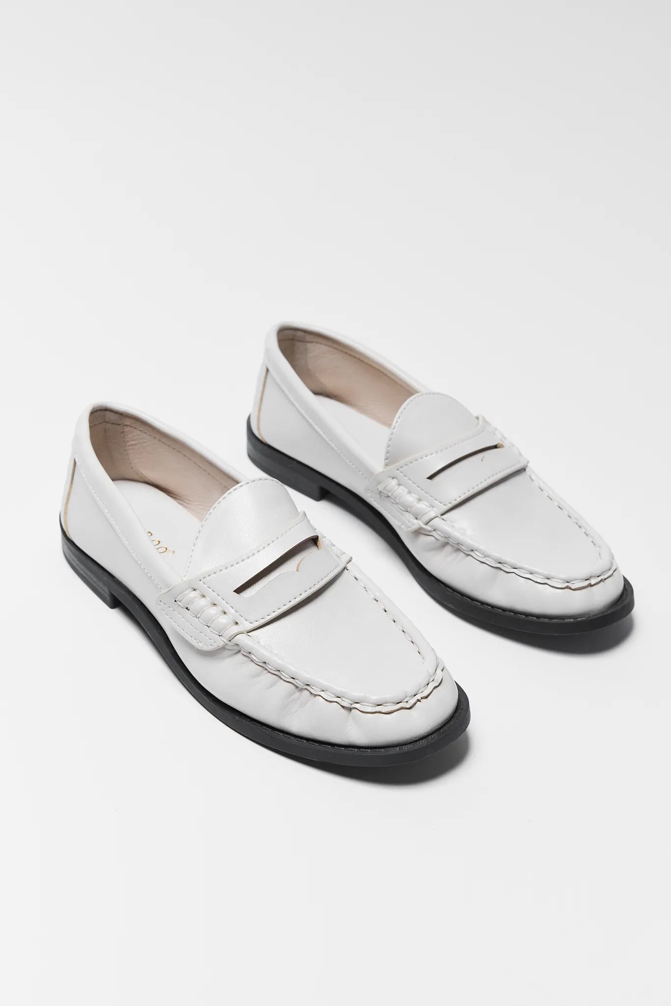 Pair of Jacklyn Cream Faux Leather Loafers on a light gray background