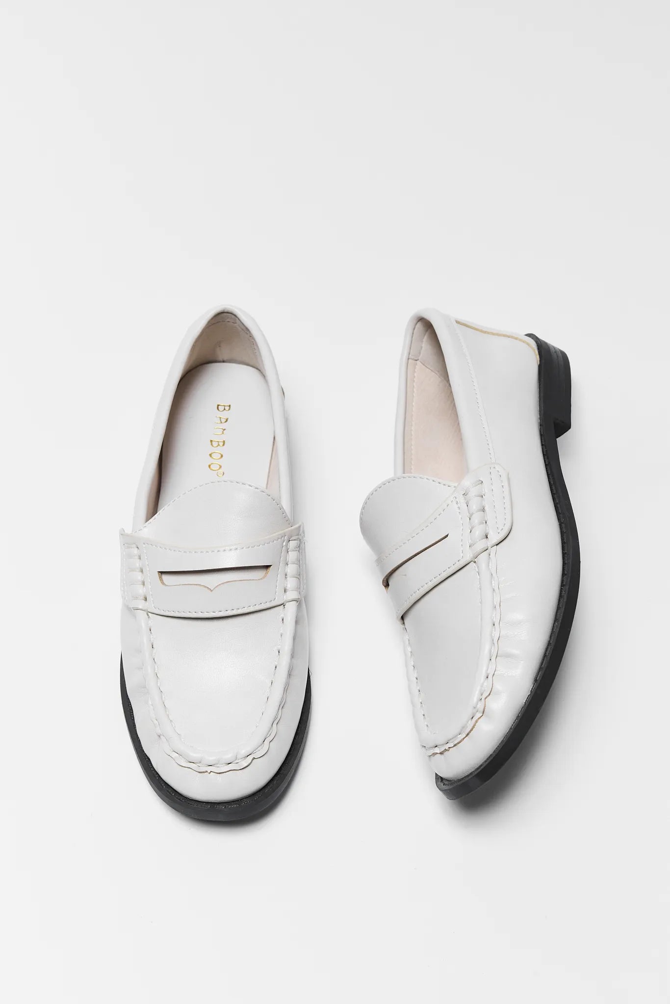 Pair of Jacklyn Cream Faux Leather Loafers on a light gray background
