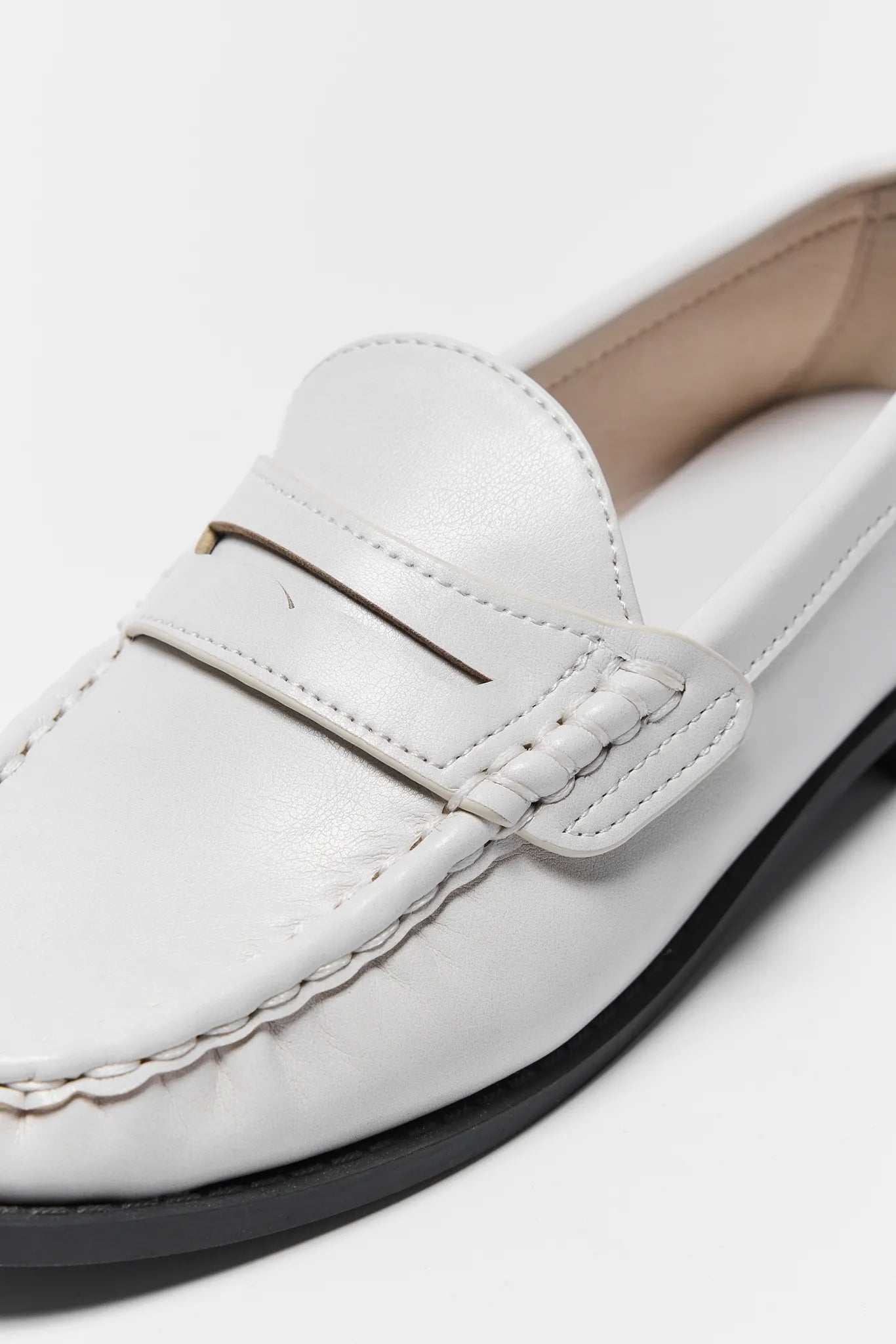 Close up of Jacklyn Cream Faux Leather Loafer on a light gray background
